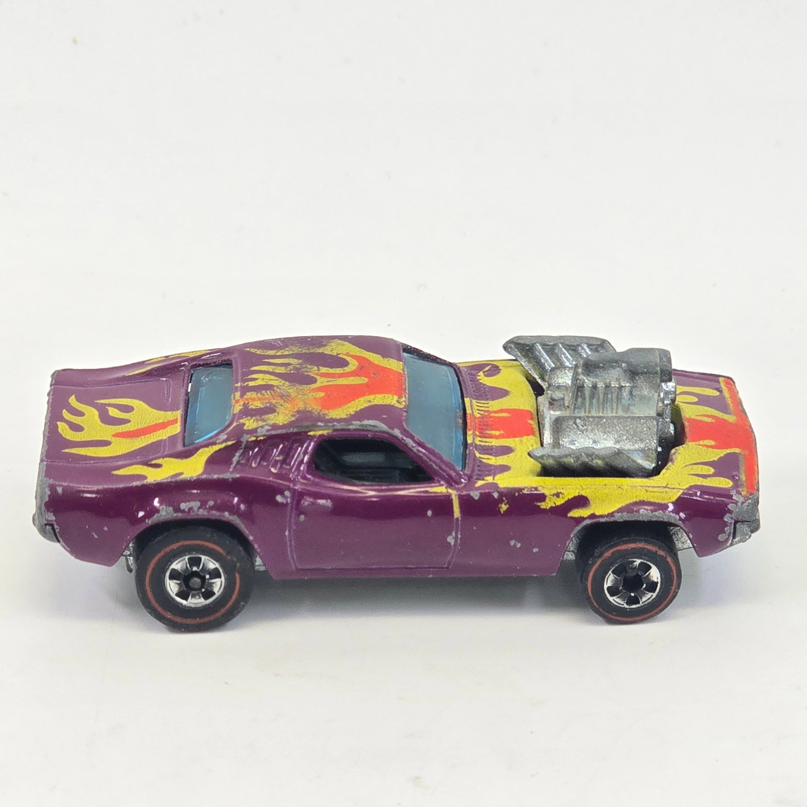 Hot Wheels Redline Rodger Dodger: Hot Wheels Redline Plum Rodger Dodger Paint: Fair with chipping and hard edge wear as seen Tampos: Mostly good with the exception of the roof with heavy wear as seen Wheel Chrome: Good with ligh