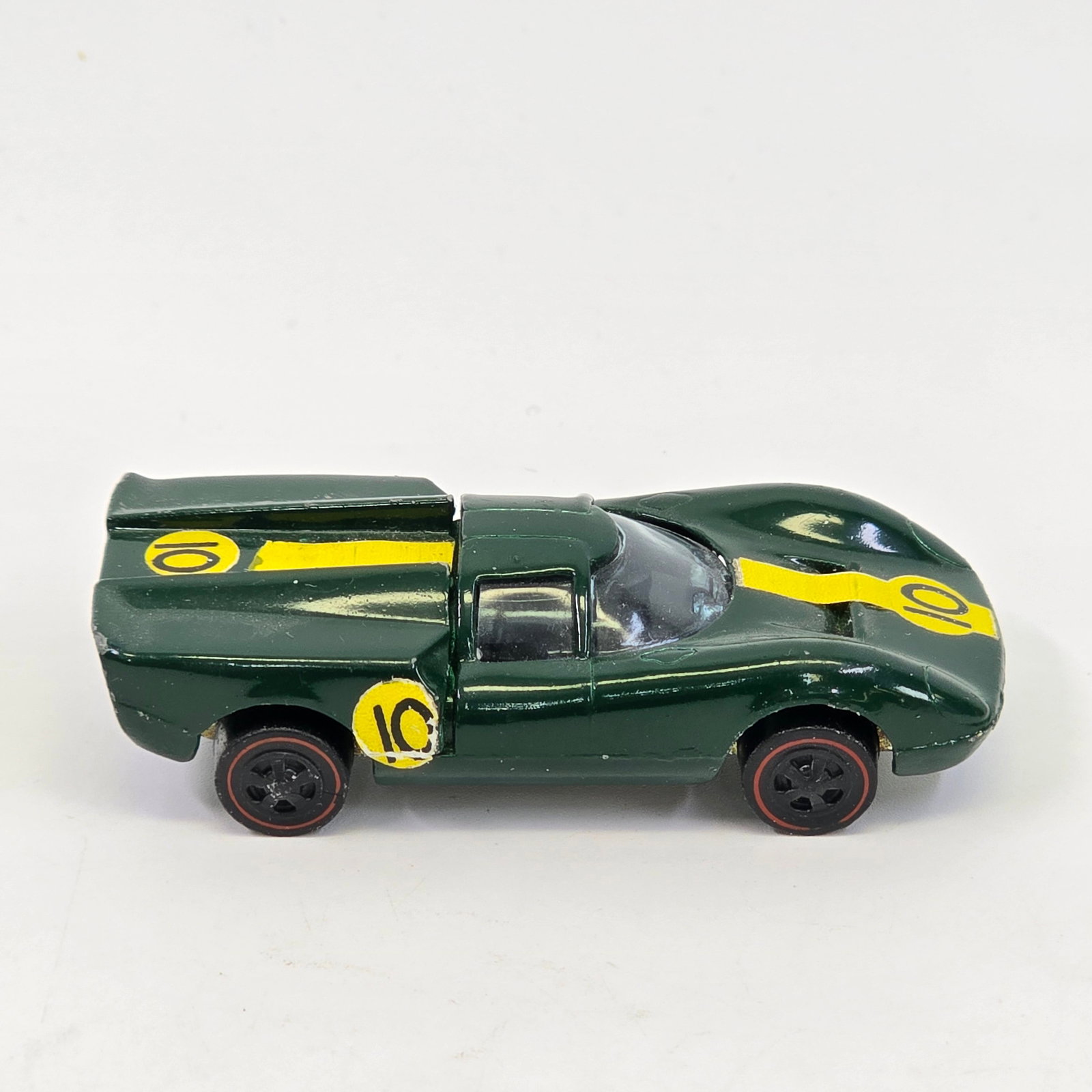 Hot Wheels Redline Lola GT: Lola GT - Green/US/Dark int. Glass- looks to be in good shape, no major damage Wheels - poor, missing most of their chrome Base & engine- clean, engine chrome is bright Paint- Paint is clean but h