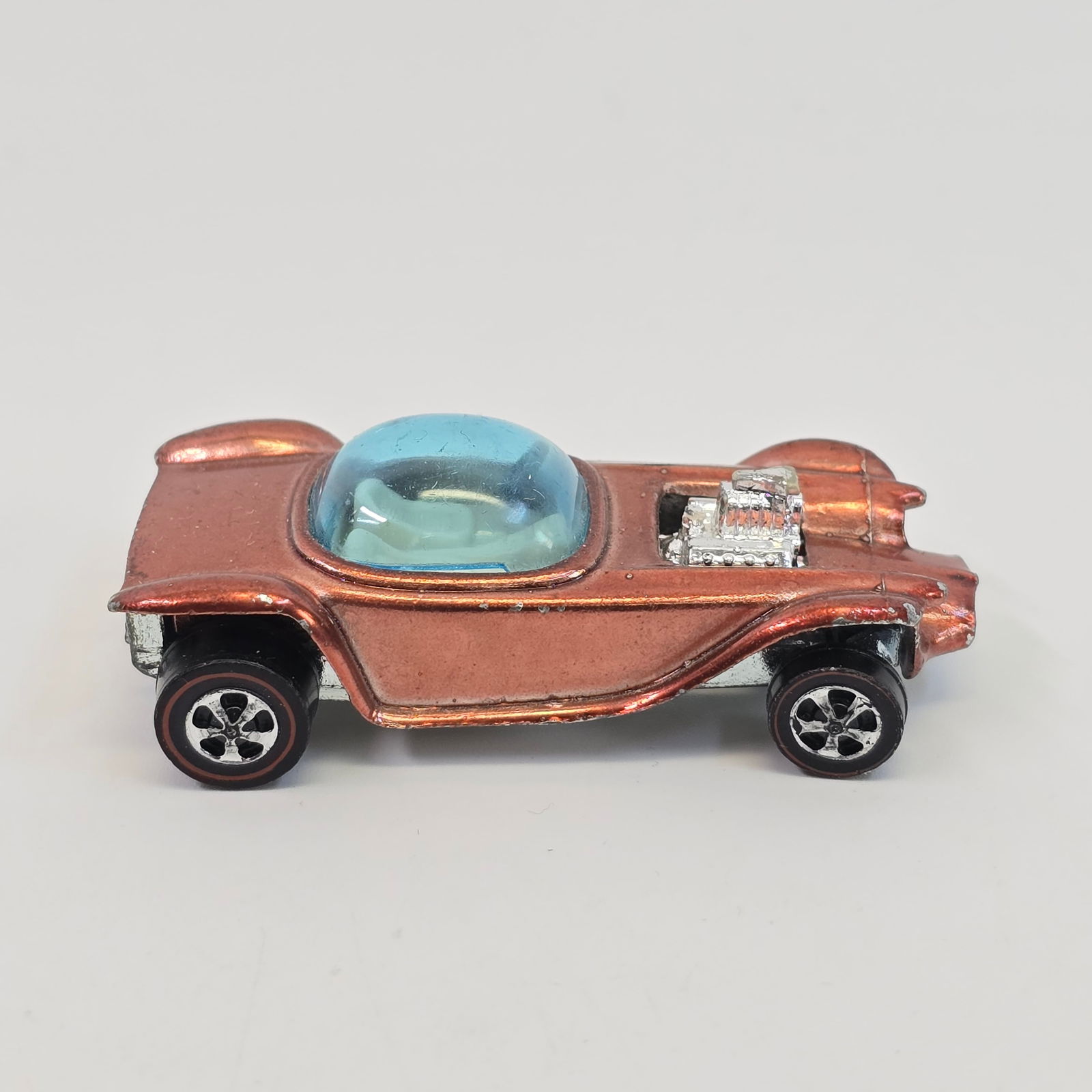 Hot Wheels Redline Beatnik Bandit: Car body/paint/Interior- HK copper, white interior, paint is consistent light shade throughout, has peppering along both sides at hard edges, all four corners have wear as well. Taillight paint is mos
