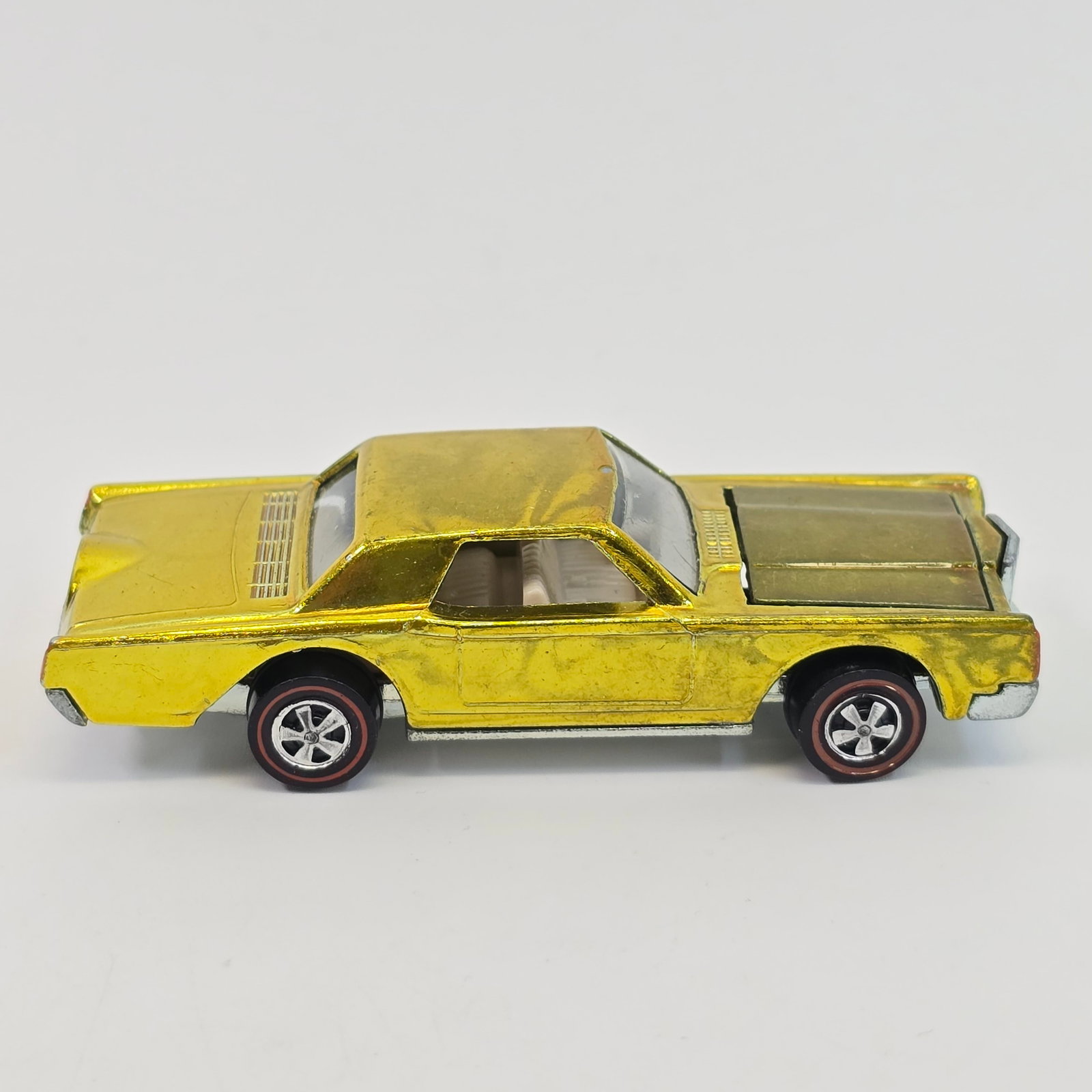Hot Wheels Redline Continental: Car body/paint/Interior - US, yellow, white interior, paint is very good but has swirly toning throught as seen, hood is darker, does have a chip at front edge of the roof, tail and front marker light
