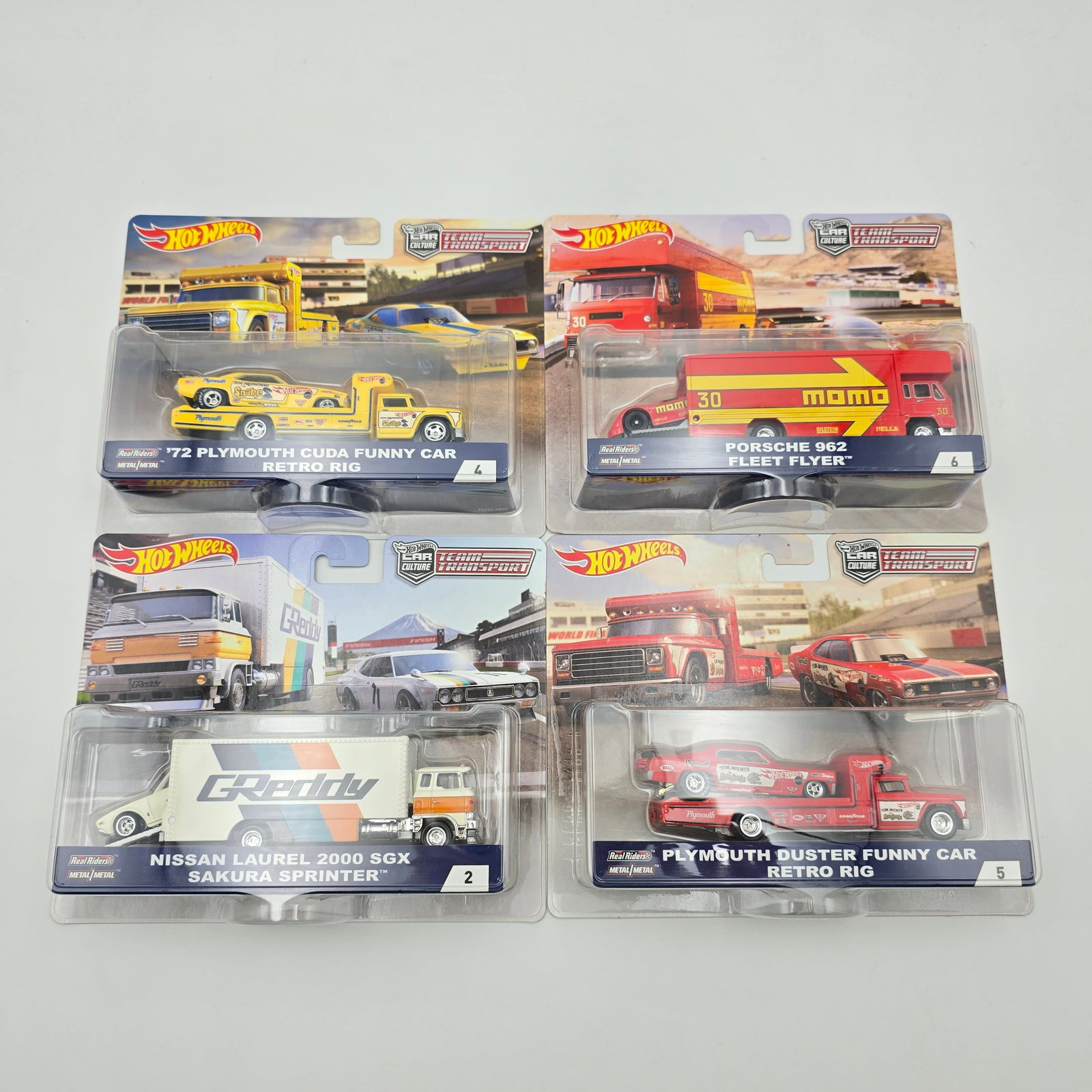 Hot Wheels Team Transport lot of 4: Hot Wheels Car Culture Team Transport lot of 4, includes - Snake and Mongoose with Transporters, Porsche 962 Fleet Flyer and Nissan Laurel 2000GTX Sakura Sprinter Cars and trucks are excellent with