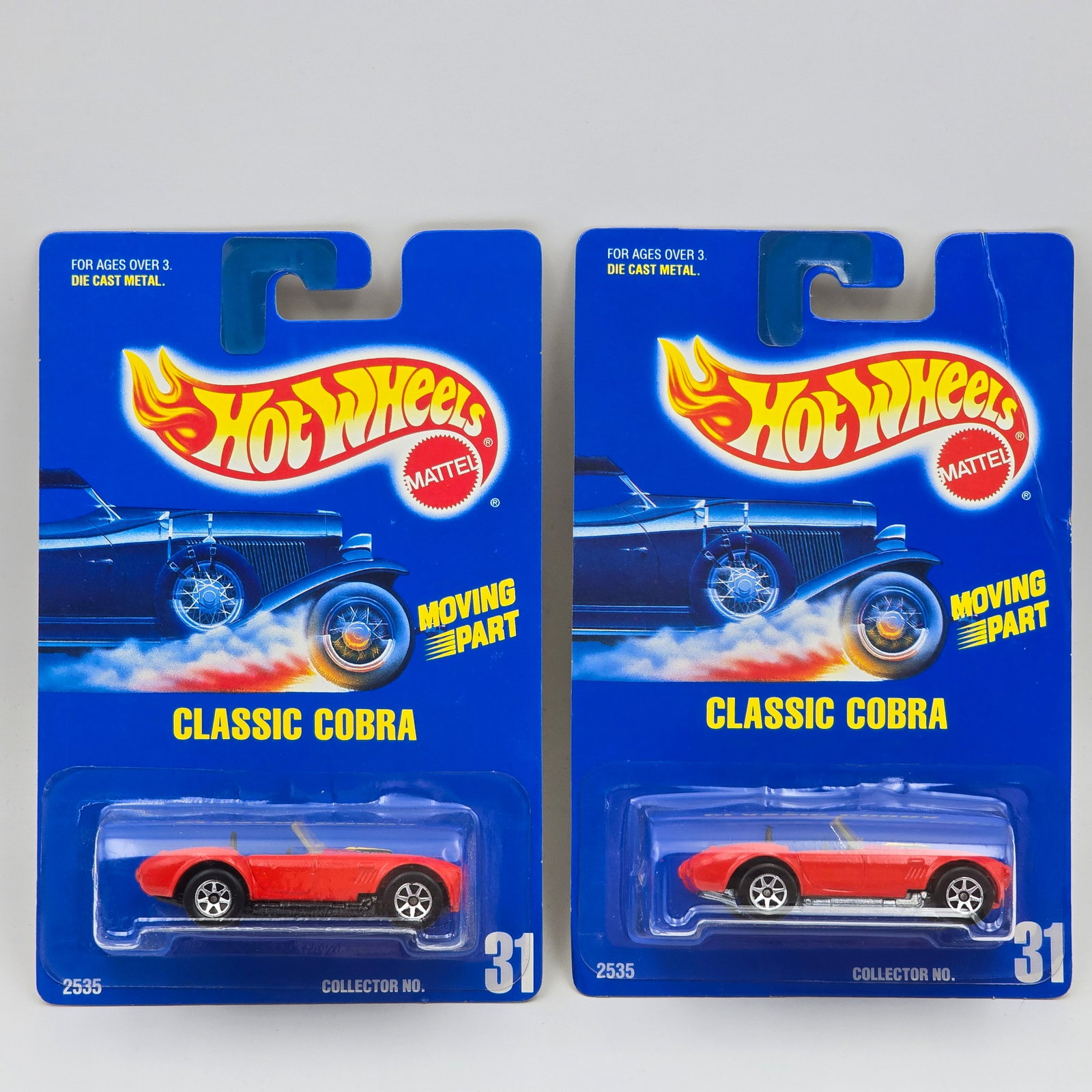 Hot Wheels Red Classic Cobra Pair: Hot Wheels #31 Red Classic Cobra Pair Both have 7 - Spoke wheels but one has a Zamac base the other has a black painted metal base and both are on the solid blue numbered card Cars appear to be in goo