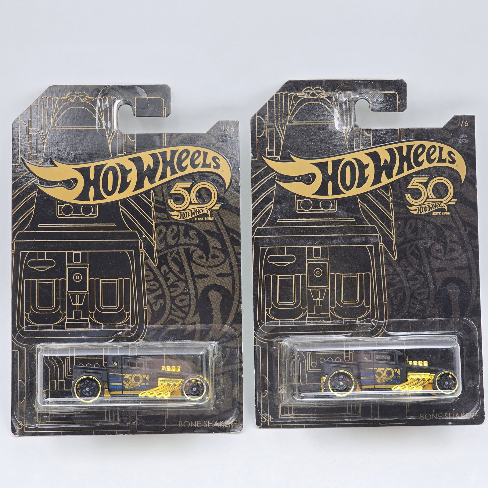 Hot Wheels Boneshaker Pair: Hot Wheels 50th Anniversary Boneshaker Pair Card variation- one has the double bone shaker card art on the back Cars appear to be in good condition with no issues of note Cards are in good shape