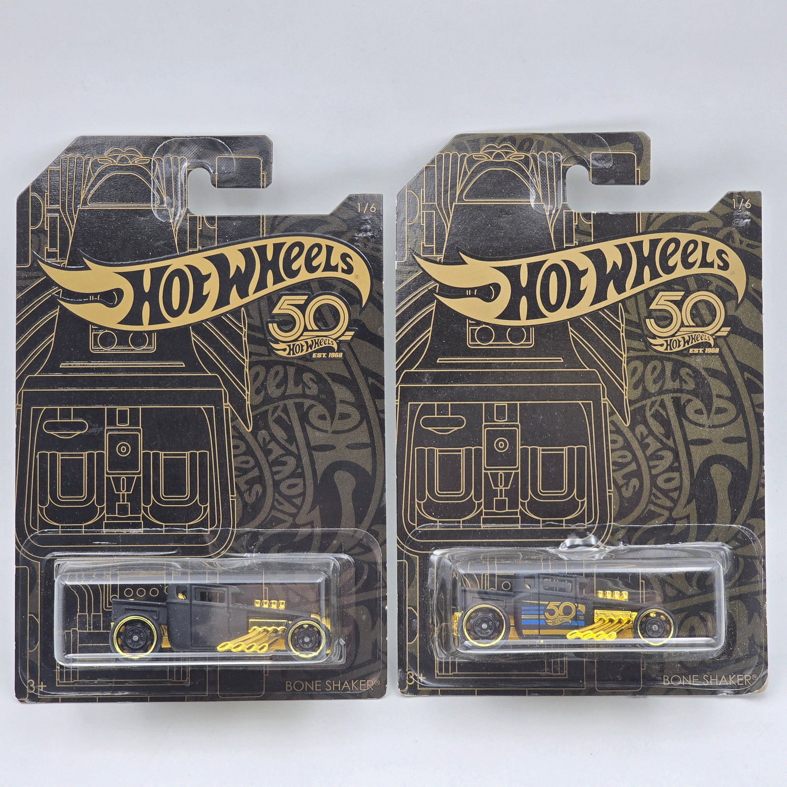 Hot Wheels Boneshaker Pair: Hot Wheels 50th Anniversary Boneshaker Pair One missing the tampos and BOTH with the back card art variation showing double bone shakers Cars appear to be in good condition with no issues of note Card