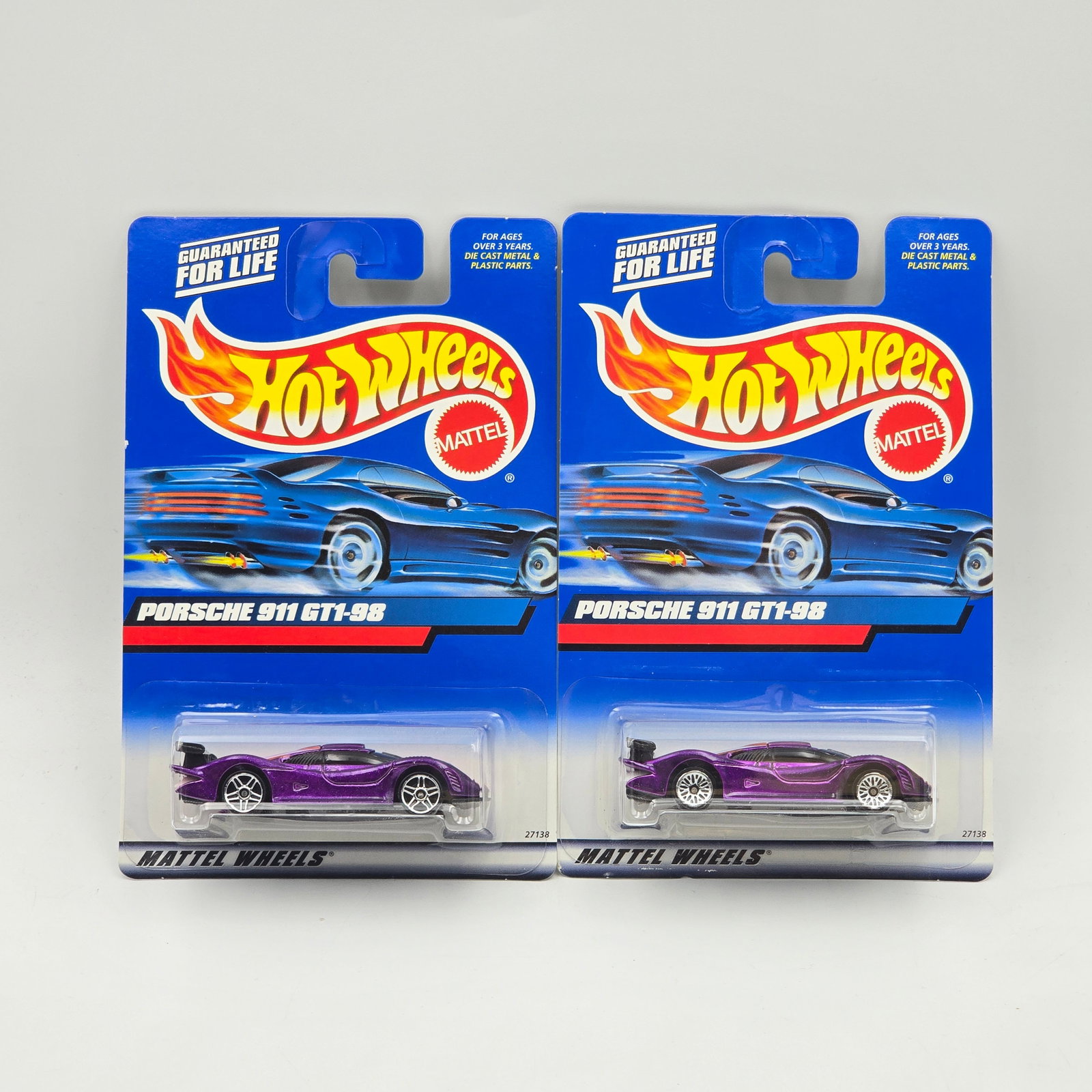 Hot Wheels Porsche 911 Pair: Hot Wheels purple Porsche 911 GT1-98 pair One has lace wheels, the other has PR5 wheels Cars appear to be excellent to near mint with no issues of note Cards are good but may have edge dings, small cr