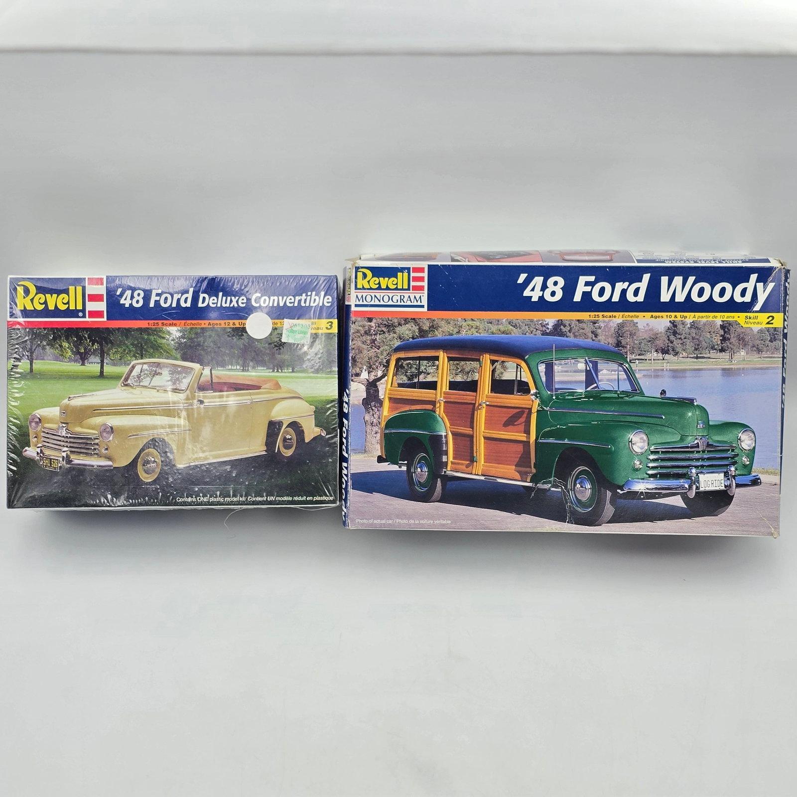 Pair of Revell Model Kits: Lot includes two Revell Model Kits, both with the box and both appear to be complete and unassembled. 1-48 Ford Deluxe Convertible, looks to be factory sealed/unopened. 1-48 Ford woody,