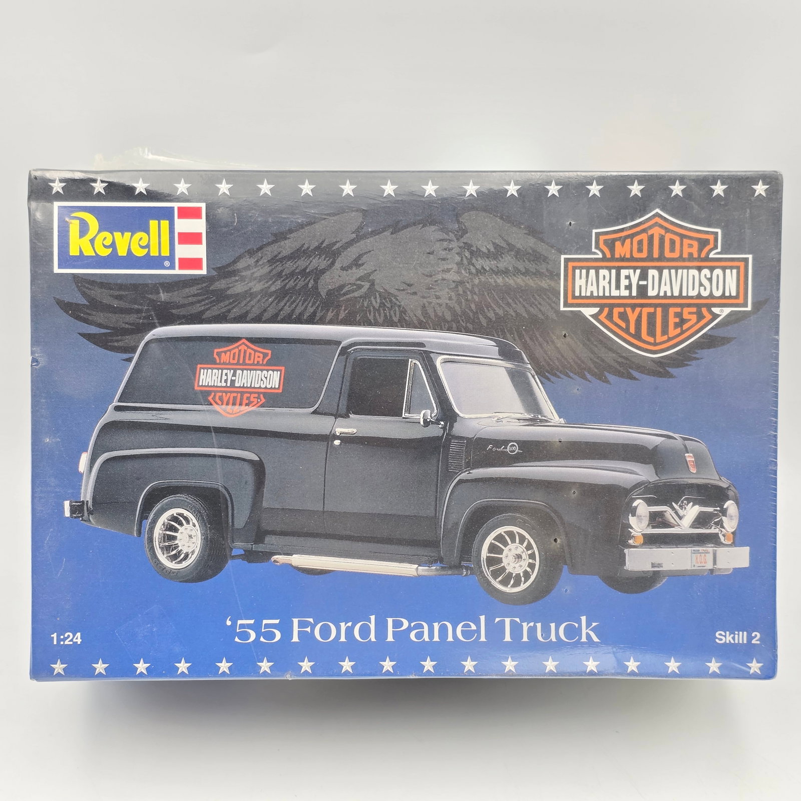 Revell Ford Model Kit: This lot includes a Revell '55 Ford Panel Truck x Harley Davidson model kit (1996) With box and appears to be complete and unassembled. Factory sealed with a rip on one side, see photos for