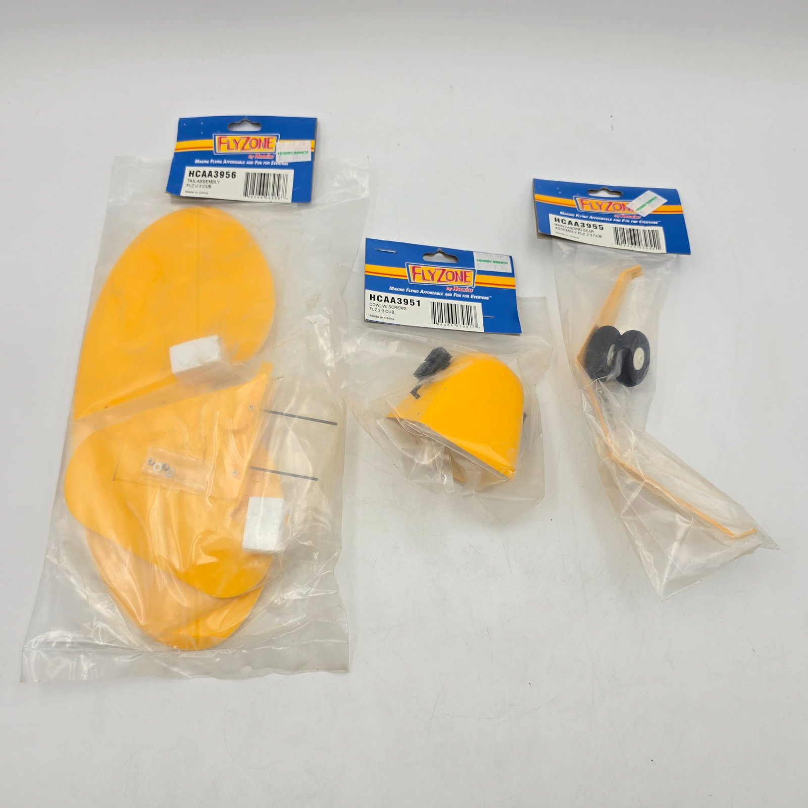 Fly Zone RC Airplane Lot: Fly Zone RC Airplane lot Includes - Cowl assembly, tail assembly and landing gear These are new old stock and factory sealed as seen Please see photos for complete description of what is included