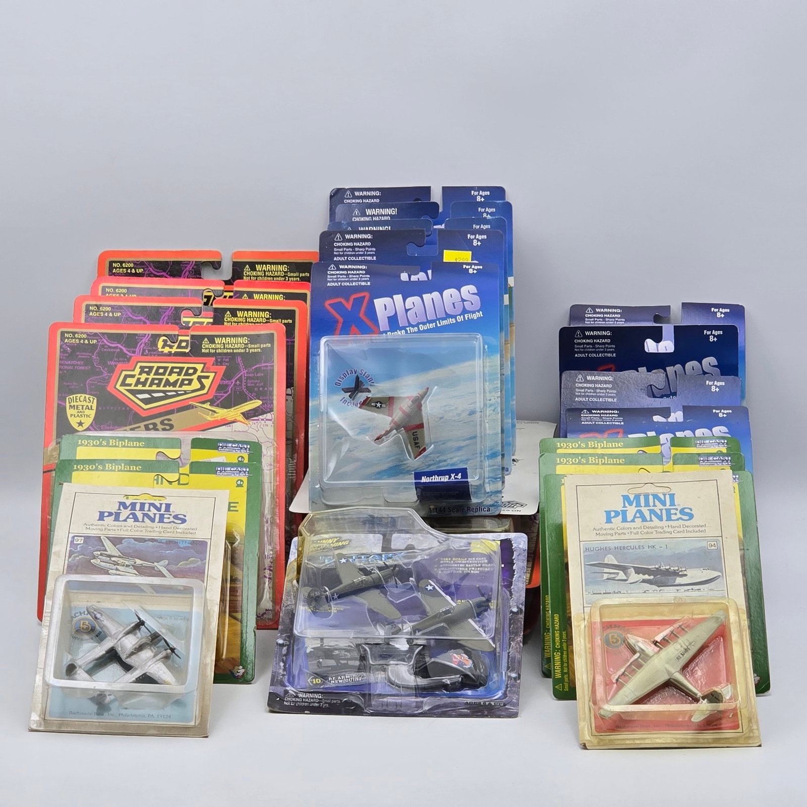 Lot of 25 Diecast Aircraft: Lot of 25 diecast aircraft including X Planes, Road Champs and more. All blisters look to be attached to the cards, most are nice and clear with some showing yellowing. Most look to 