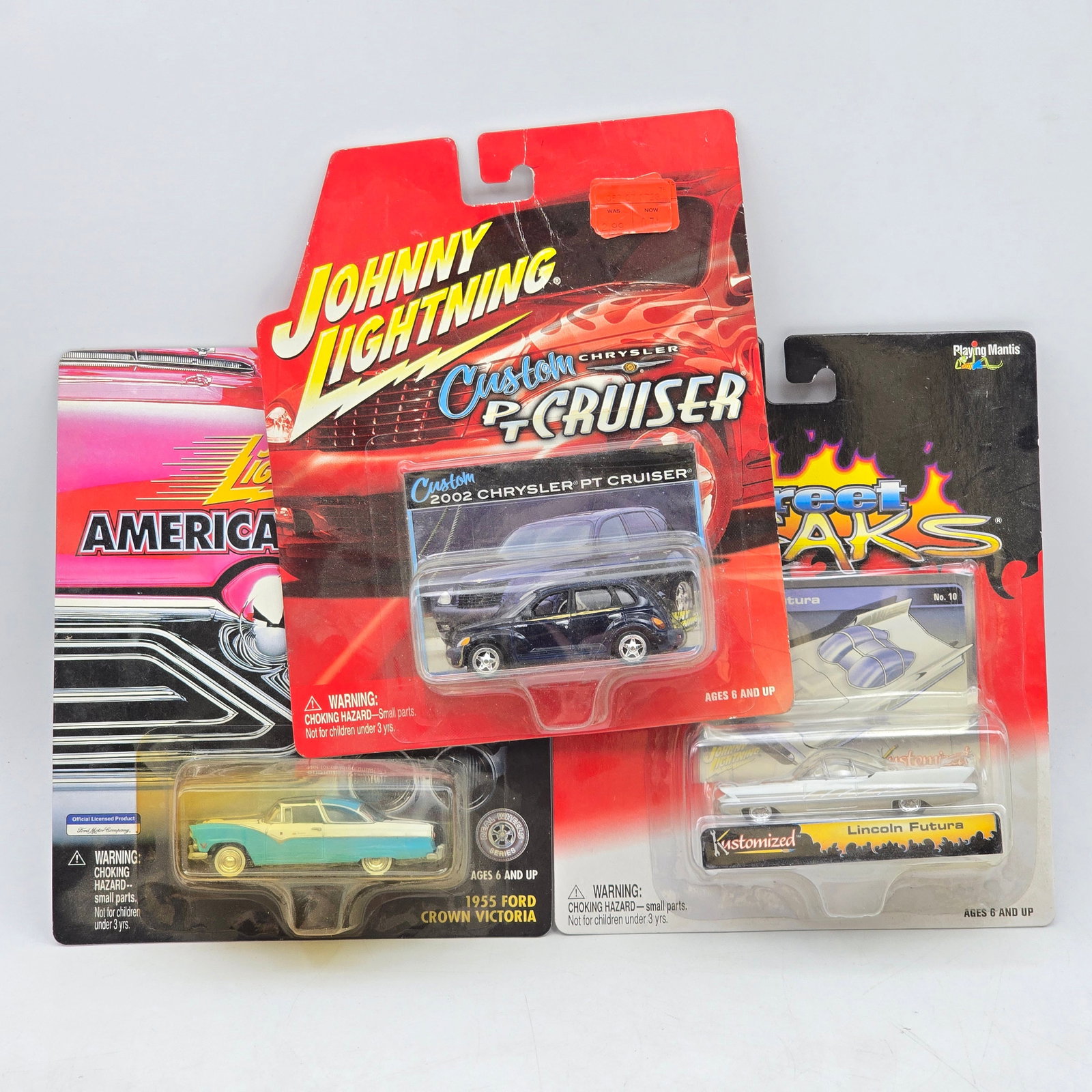Lot of 3 Johnny Lightning Diecast: Lot of 3 Johnny Lightning Diecast Vehicles including: 1- 2002 Chrysler PT Cruiser (Custom series) 2- 1955 Ford Crown Victoria (American Chrome series) 3- Lincoln Futura (Street Freaks series)