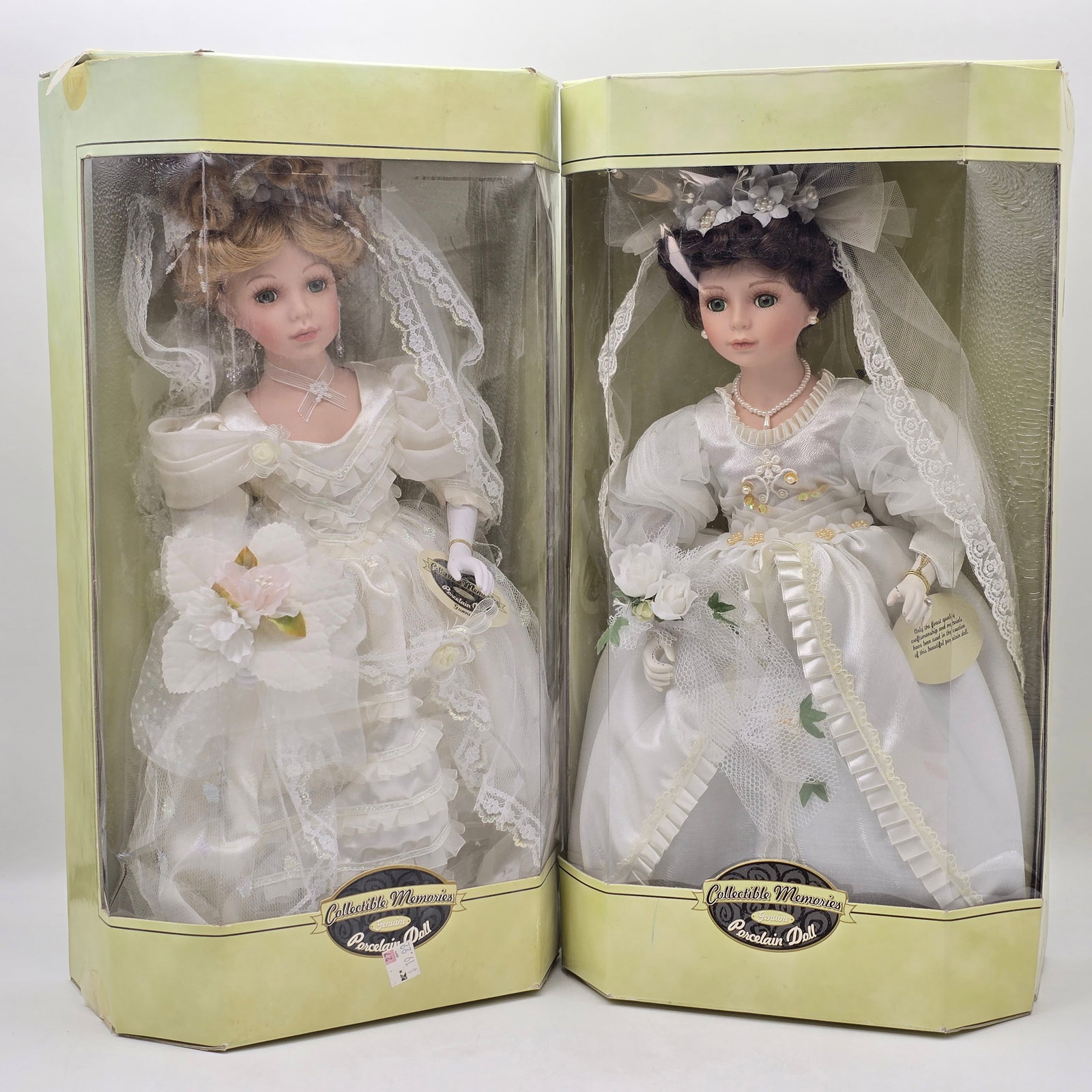 Pair of Porcelain Dolls: Lot of 2 Collectible Porcelain Dolls including: 1- Porcelain Doll in White Wedding Dress with Veil and Floral Bouquet 2- Porcelain Doll in White Wedding Dress with Veil and Lace Detail Both dolls are 