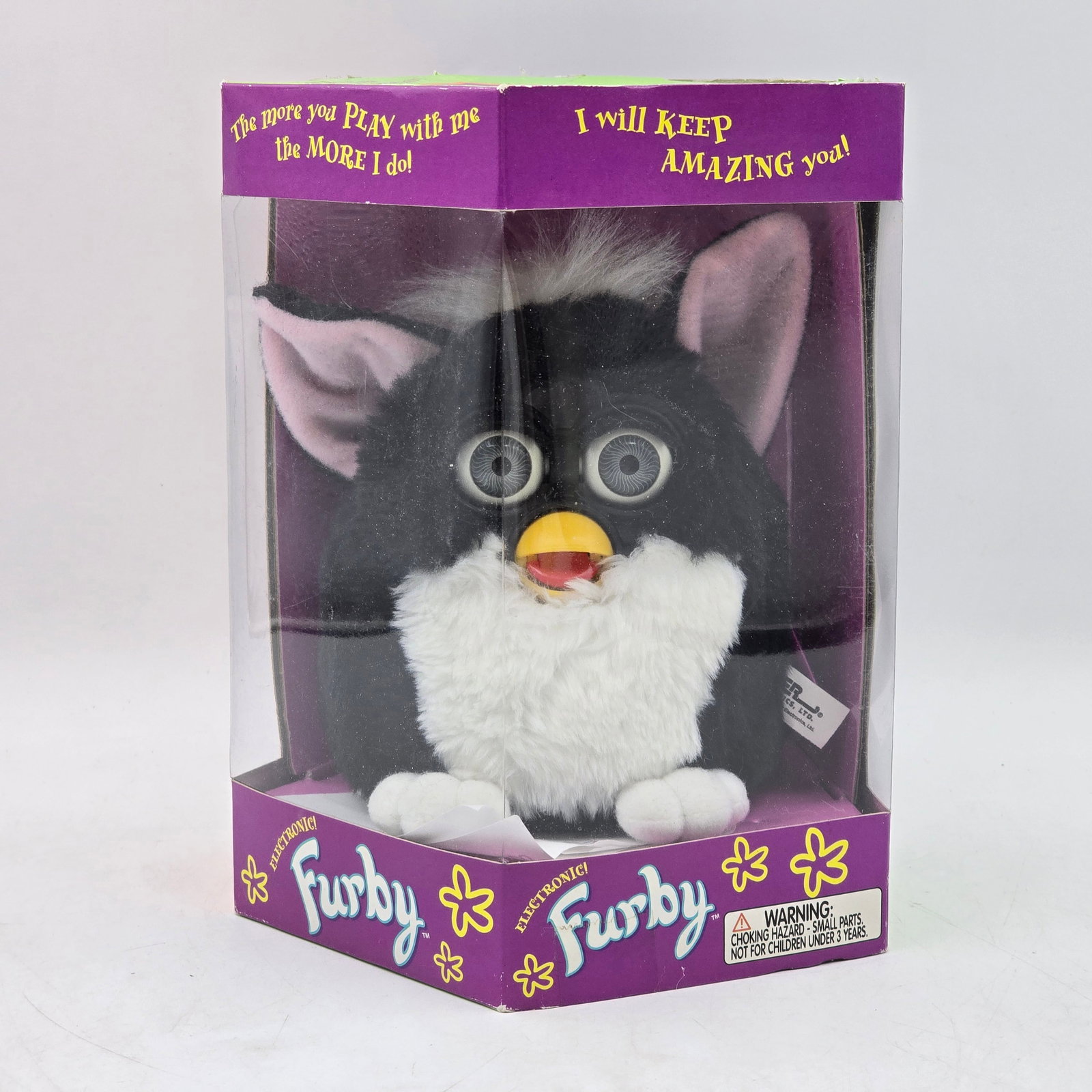 Furby Electronic Toy in Box: Original Furby electronic toy in original packaging. Features classic black and white Furby with signature moving eyes and interactive functions. Item appears unused and remains in original box. Box s