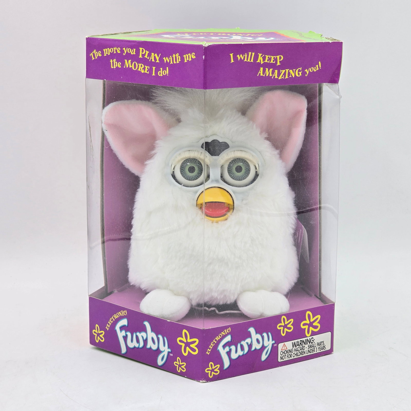 Furby White Electronic Toy with Box: Original Furby electronic toy with original packaging. Features classic white Furby with pink ears and signature interactive functions. Item appears unused and remains in original box. Box shows shelf