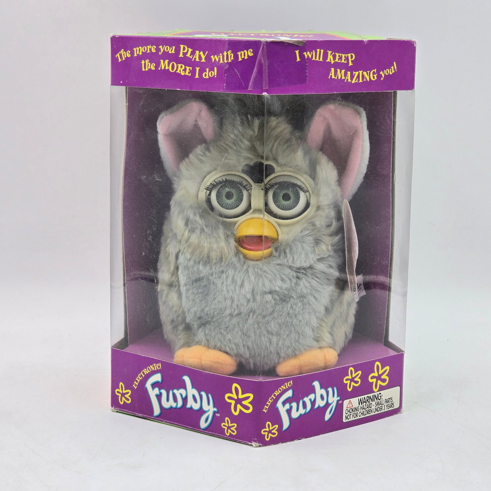 Furby Gray Electronic Toy in Box: Original Furby electronic toy with original packaging. Features gray Furby with classic interactive design and signature moving eyes. Packaging has been opened. Furby appears clean with minimal signs 