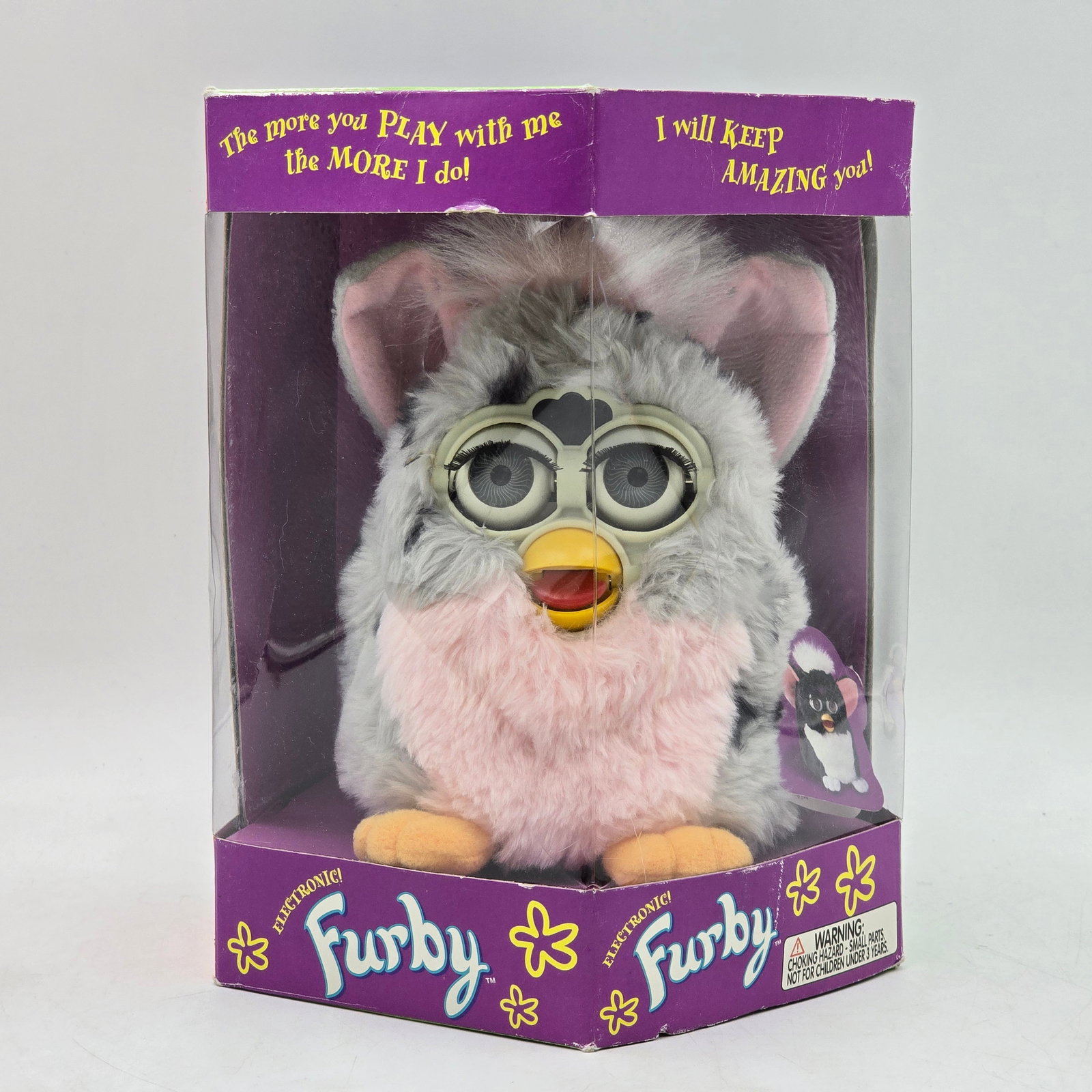 Furby Pink Gray Electronic Toy in Box: Original Furby electronic toy with original packaging. Features pink and gray Furby with classic interactive design and signature moving eyes. Packaging has been opened. Furby appears clean with minim