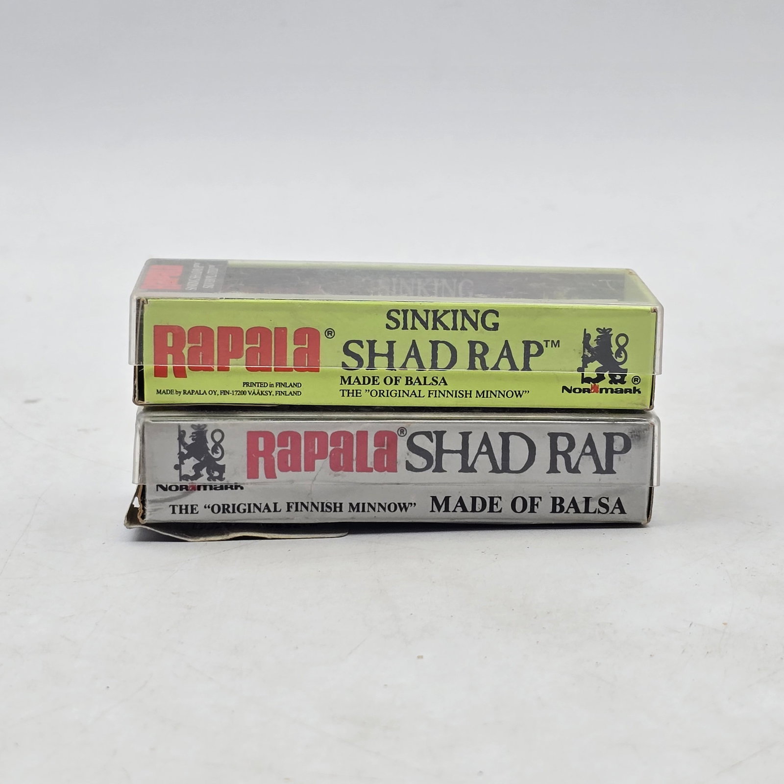 Rapala Shad Rap Lures 2pc: Lot of 2 Rapala Shad Rap Fishing Lures. Includes Rapala Shad Rap and Sinking Shad Rap models, both in original boxes. Lures show light wear from storageâ€”please review photos for exact