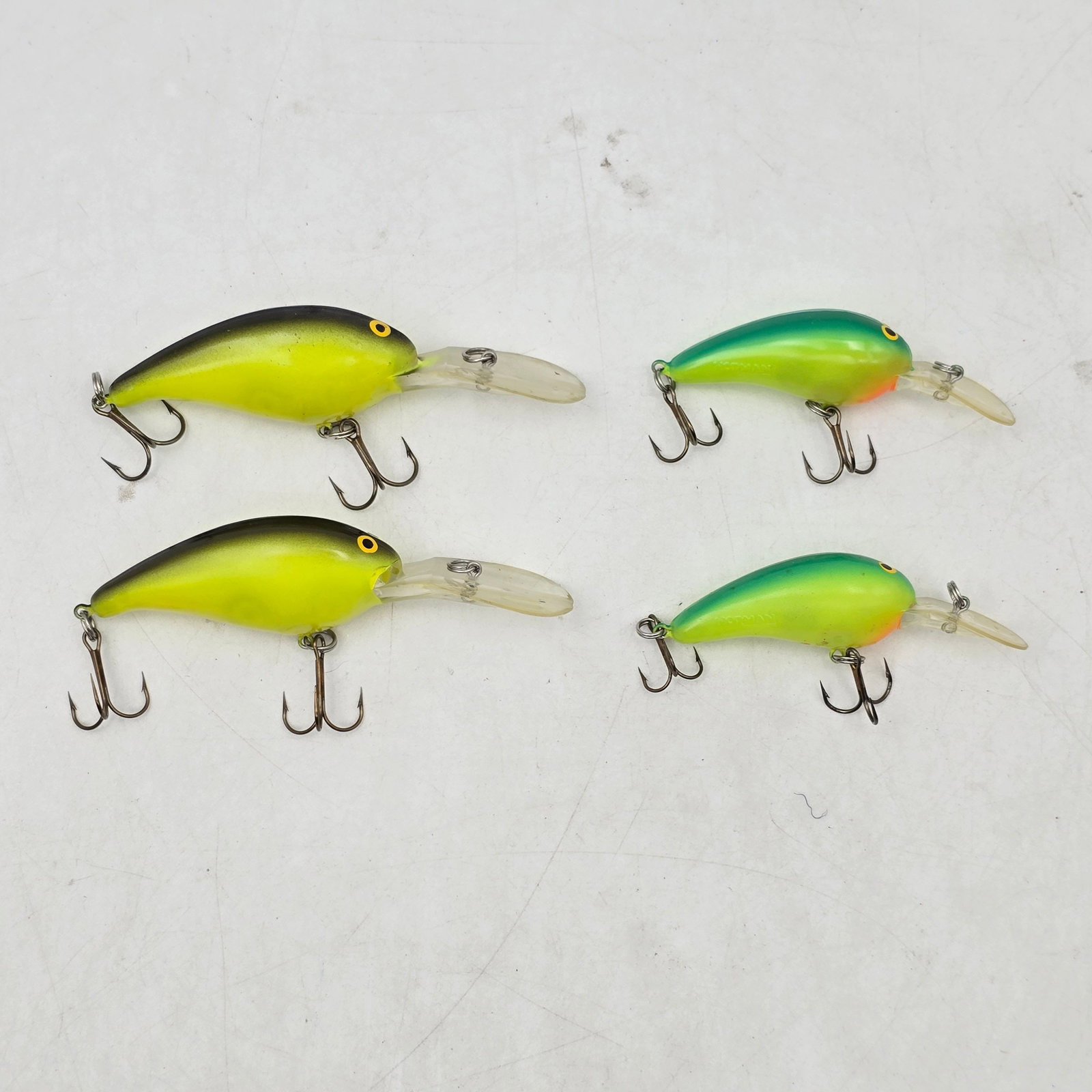 Crankbait Fishing Lures 4pc: Lot of 4 Crankbait Fishing Lures. Includes two matching pairs of crankbait-style lures in bright chartreuse and green color patterns. Lures show signs of use with minor wearâ€”please