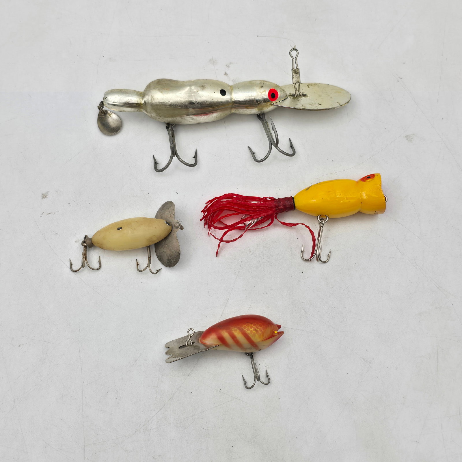 Vintage Fishing Lures 4pc: Lot of 4 Fishing Lures. Includes a mix of vintage-style lures featuring metal, jointed, and topwater designs in various shapes and finishes. A unique assortment with different action styles. Items