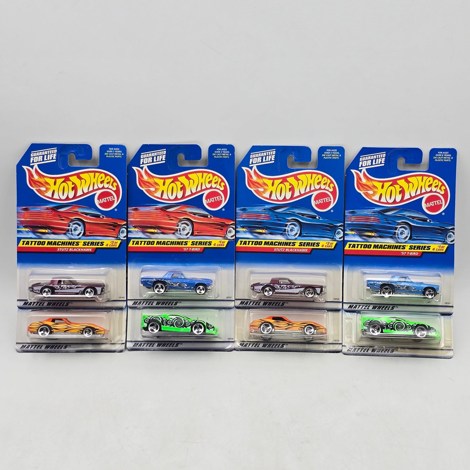 Pair of 90s Hot Wheels Sets: Lot of 8 Hot Wheels Diecast Vehicles from the Tattoo Machines Series including: 1- â€?57 T-Bird 2- â€?93 Camaro 3- Stutz Blackhawk 4- â€?63 Corvette Includes