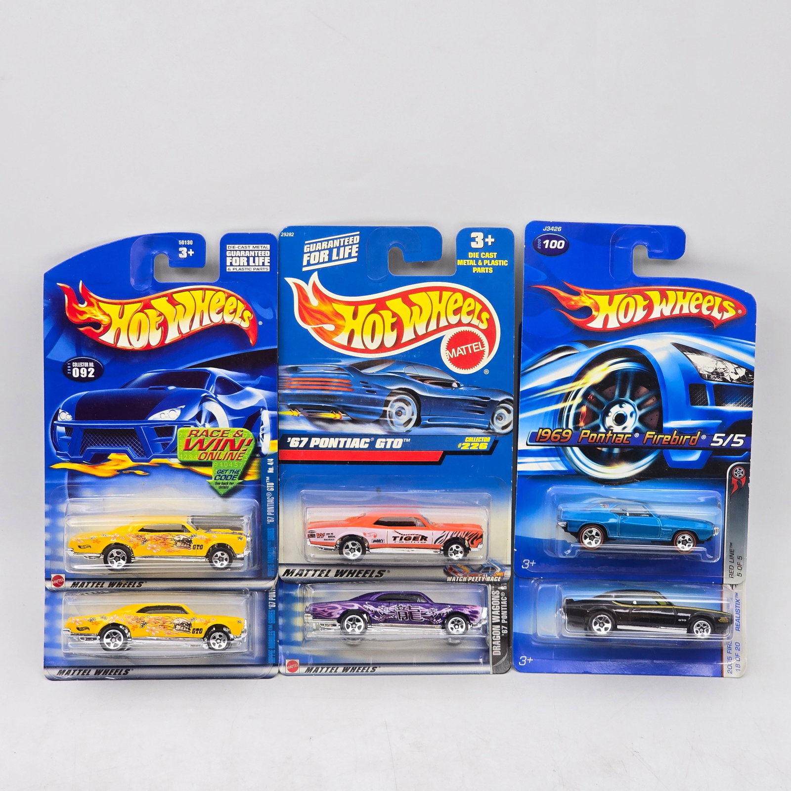 Lot Of 6 Hot Wheels Pontiac Models: Lot of 6 Hot Wheels diecast Pontiac castings. Includes GTO and Firebird-style models, with a mix of muscle-era designs in varied colors and deco. All items are unopened in original blister packaging. 