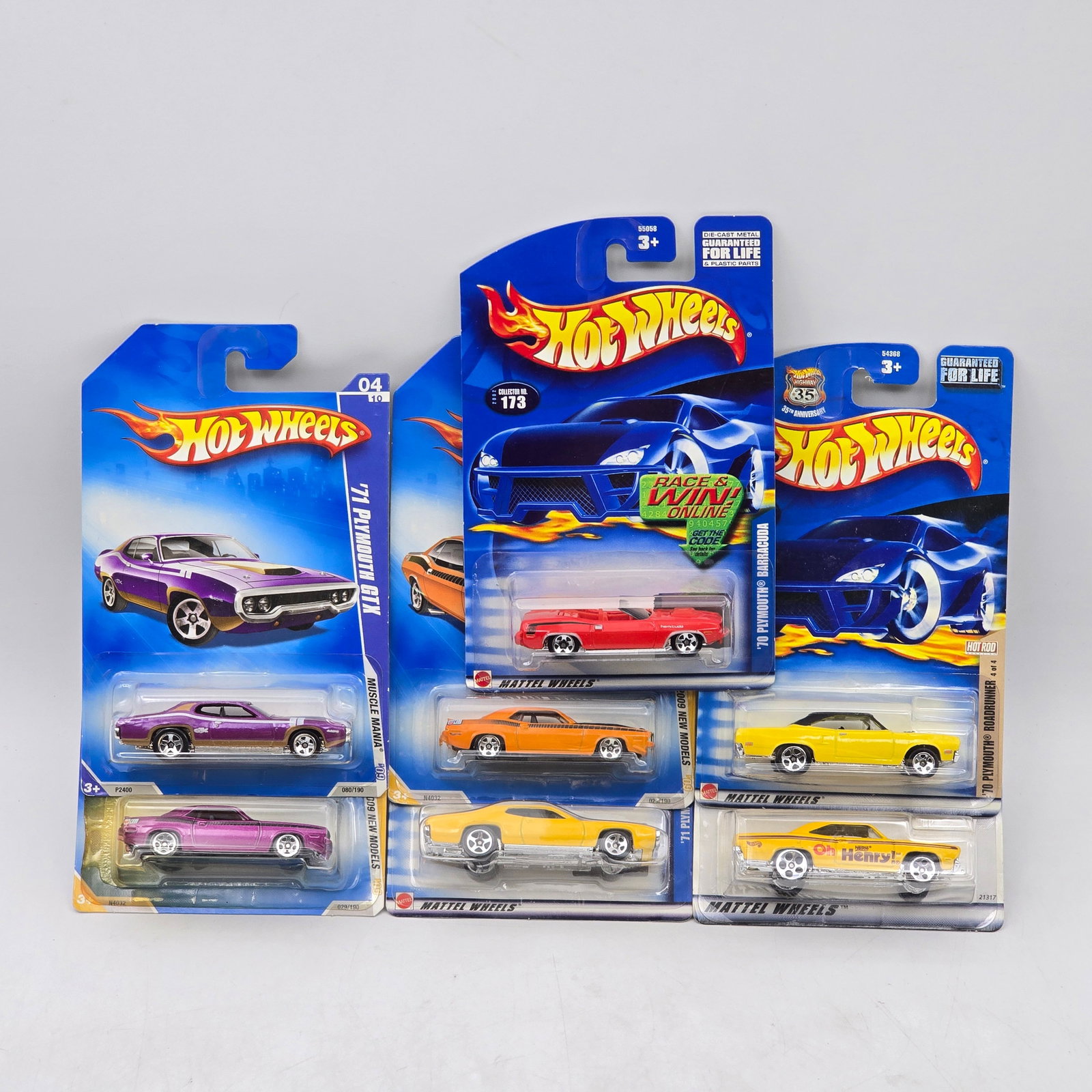 Lot Of 7 Hot Wheels Plymouth Muscle Cars: Lot of 7 Hot Wheels diecast Plymouth castings. Includes Barracuda, Road Runner, and similar muscle-era models in a mix of bold colors and factory-style finishes. All items are unopened in original bli