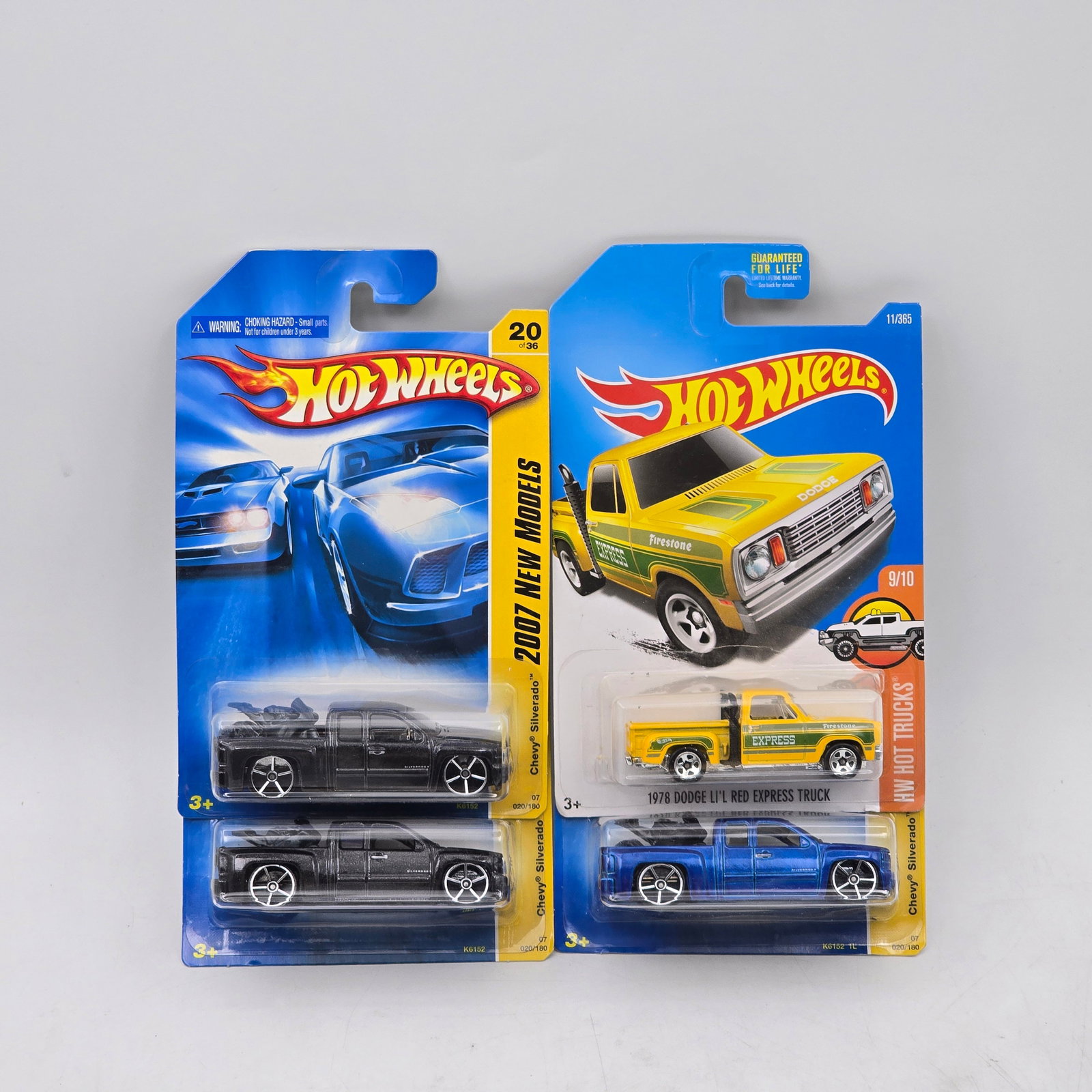 Lot Of 4 Hot Wheels Truck Castings: Lot of 4 Hot Wheels diecast truck models. Includes Chevy Silverado pickups in black along with a Dodge Lil Red Express Truck and an additional blue pickup, featuring a mix of clean finishes and graphi