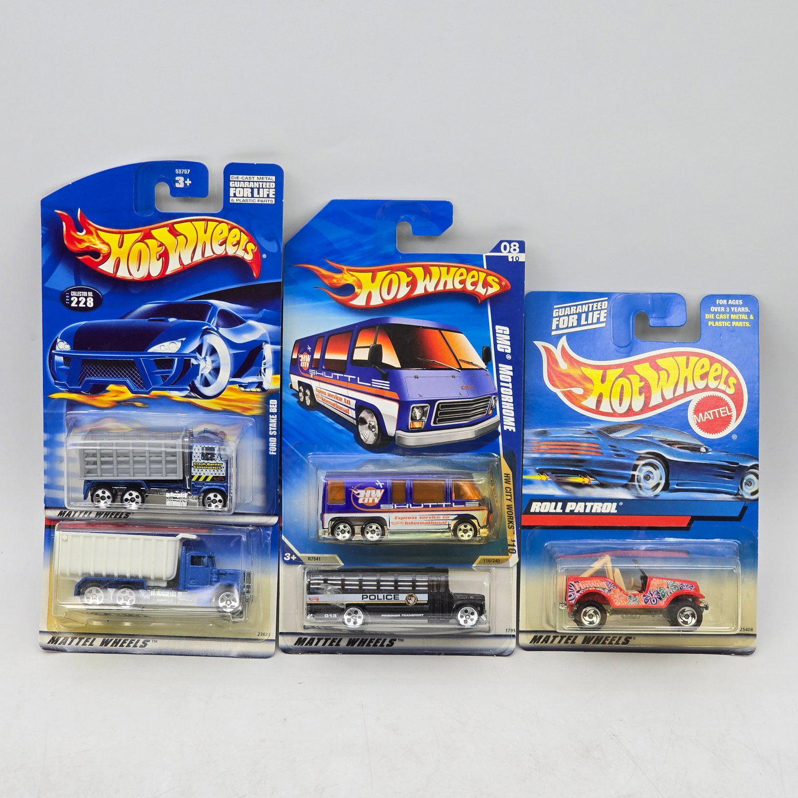 Lot Of 5 Hot Wheels Diecast Vehicle Mix: Lot of 5 Hot Wheels diecast vehicles featuring a mix of utility and novelty castings. Includes trucks, a bus-style hauler, and a Roll Patrol off-road vehicle, with varied colors and graphic deco. All 