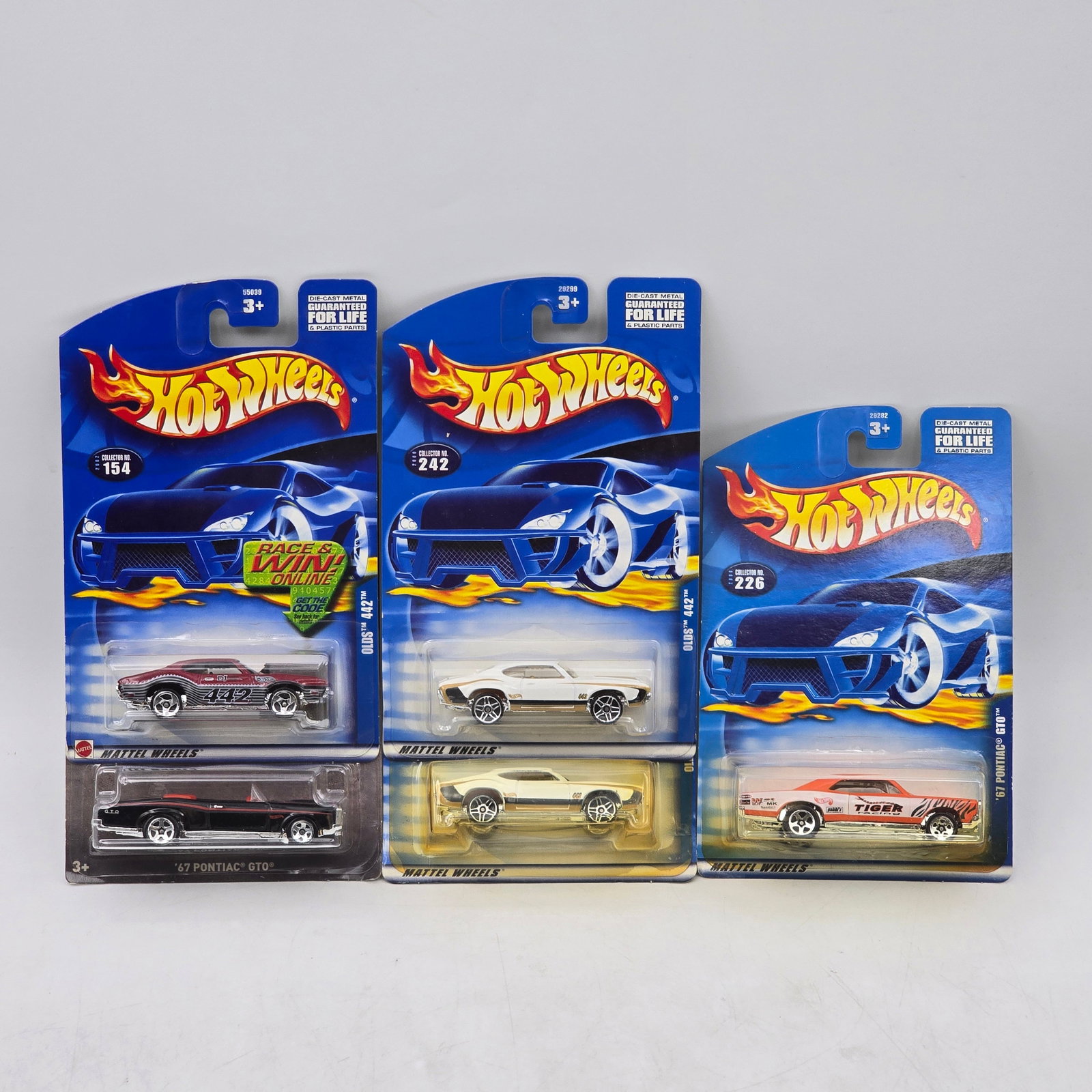 Lot Of 5 Hot Wheels Olds & Pontiac Models: Lot of 5 Hot Wheels diecast vehicles featuring Oldsmobile and Pontiac castings. Includes classic muscle-era designs such as Pontiac GTO and Olds 442-style models in red, white, black, and gold with a 