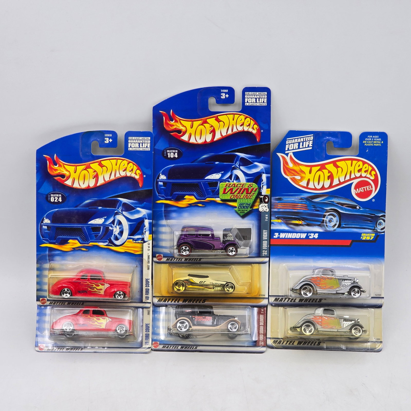 Lot Of 7 Hot Wheels Hot Rod Models: Lot of 7 Hot Wheels diecast vehicles featuring hot rod and vintage-style castings. Includes classic coupes and roadsters such as the 3-Window â€™34, along with custom builds in red, purple, go