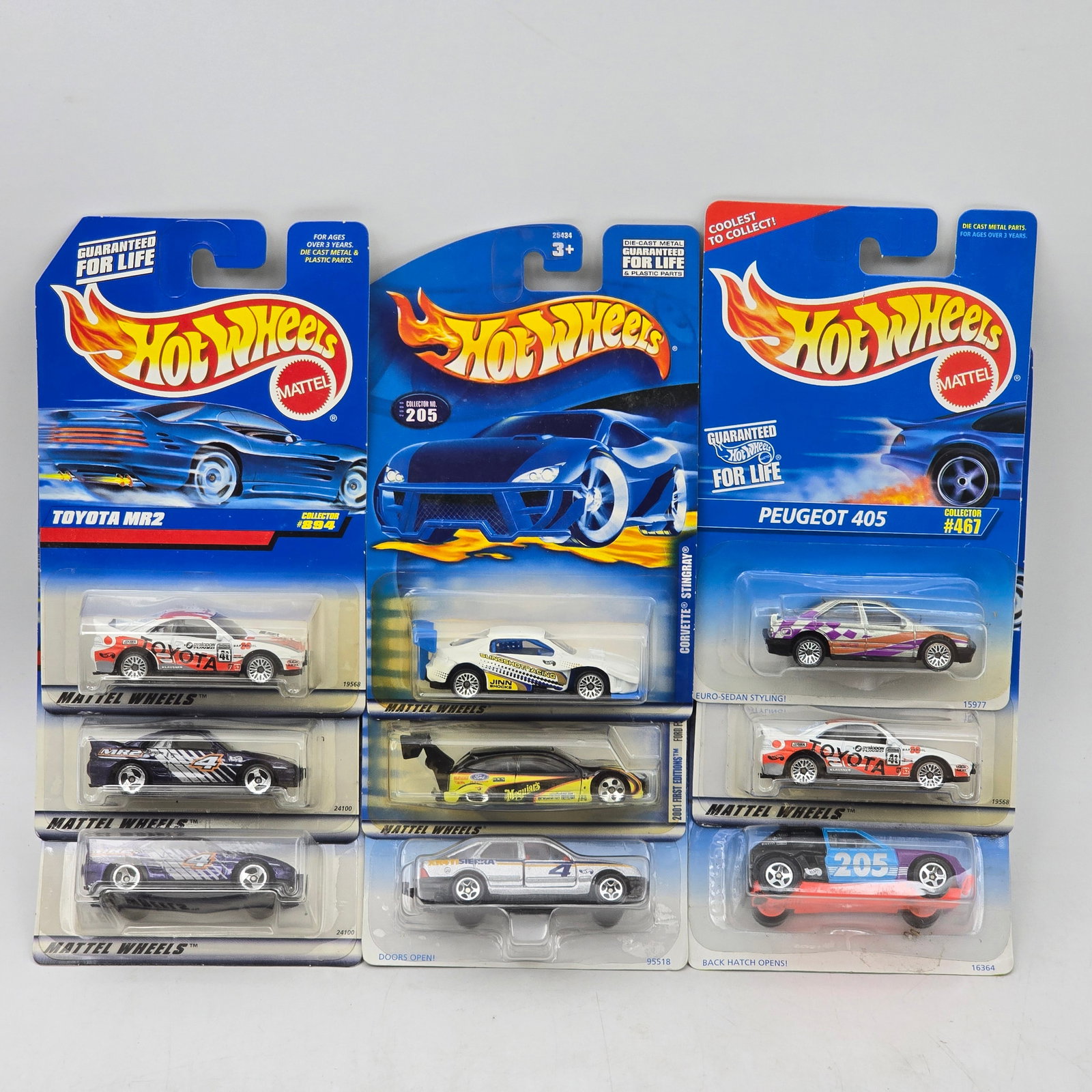 Lot Of 9 Hot Wheels Sports & Rally Models: Lot of 9 Hot Wheels diecast vehicles featuring a mix of sports and rally-style castings. Includes Toyota MR2, Peugeot 405, and other performance models with racing graphics and varied color schemes. A