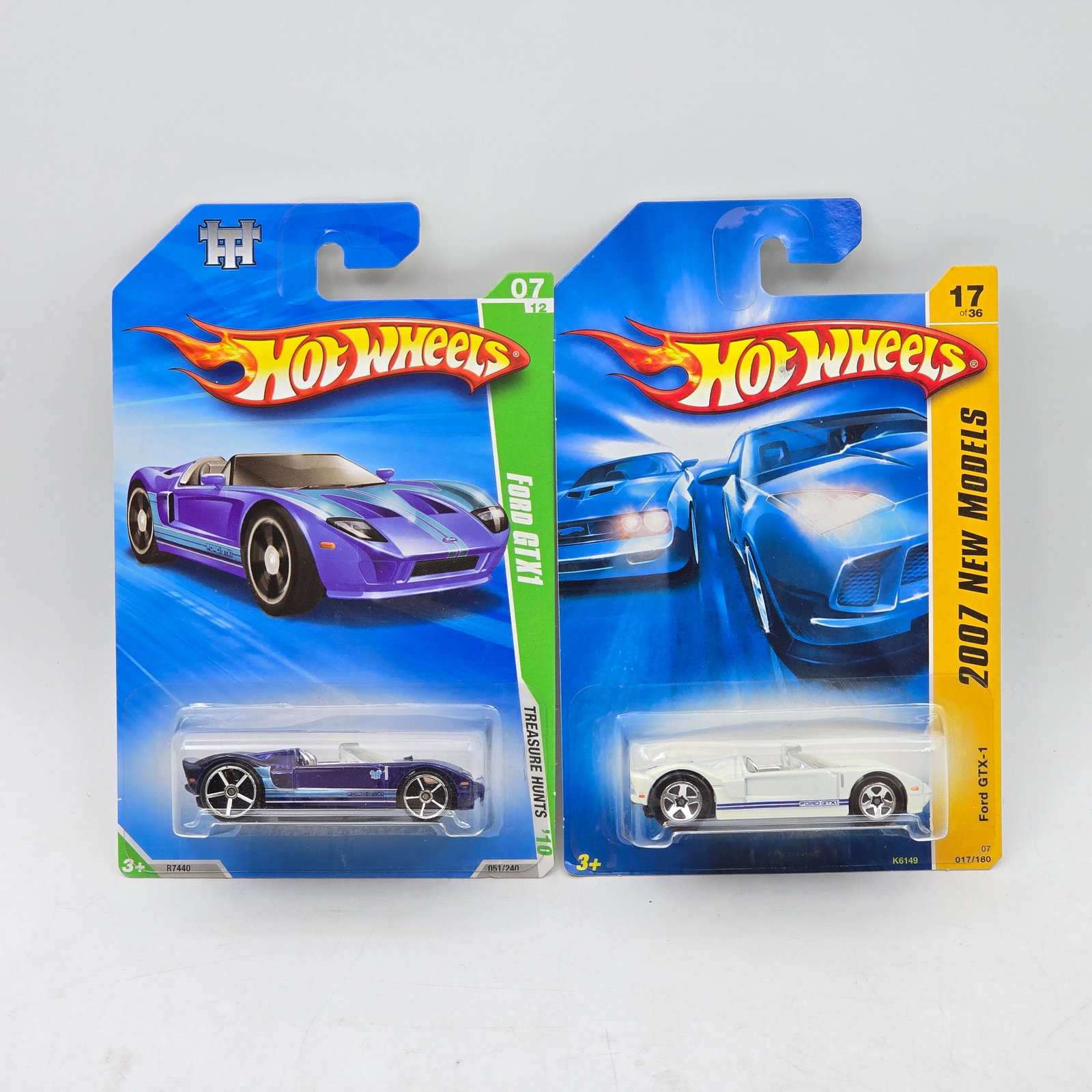 Pair Of Hot Wheels Ford GTX-1 Models: Pair of 2 Hot Wheels diecast Ford GTX-1 castings. Includes one standard release and one Treasure Hunt variation, both featuring clean, high-performance styling in white and purple. All items are unope