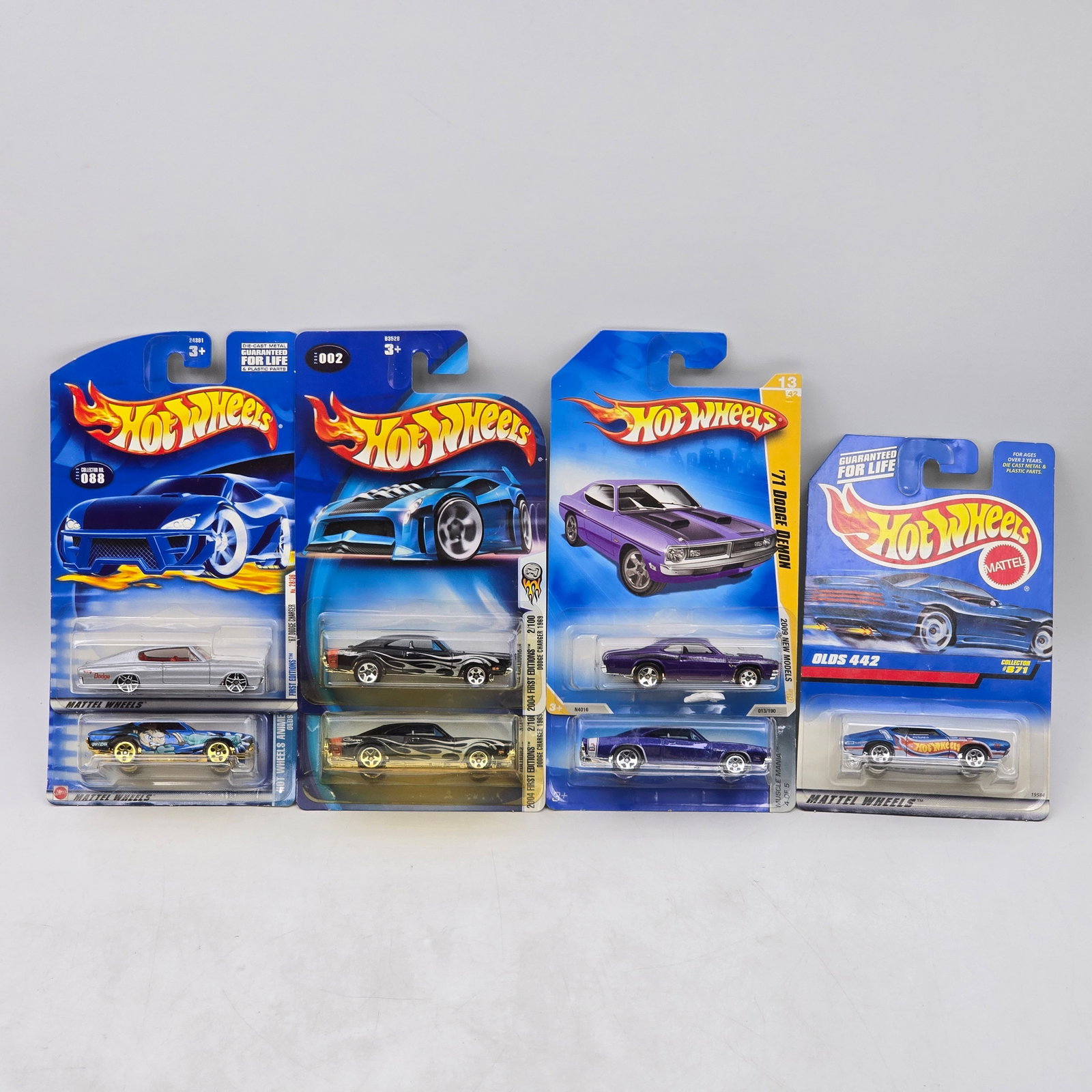 Lot Of 7 Hot Wheels American Muscle Models: Lot of 7 Hot Wheels diecast vehicles featuring classic American muscle castings. Includes Dodge Demon, Olds 442, and other muscle-era designs in black, purple, blue, and white with a mix of clean fini