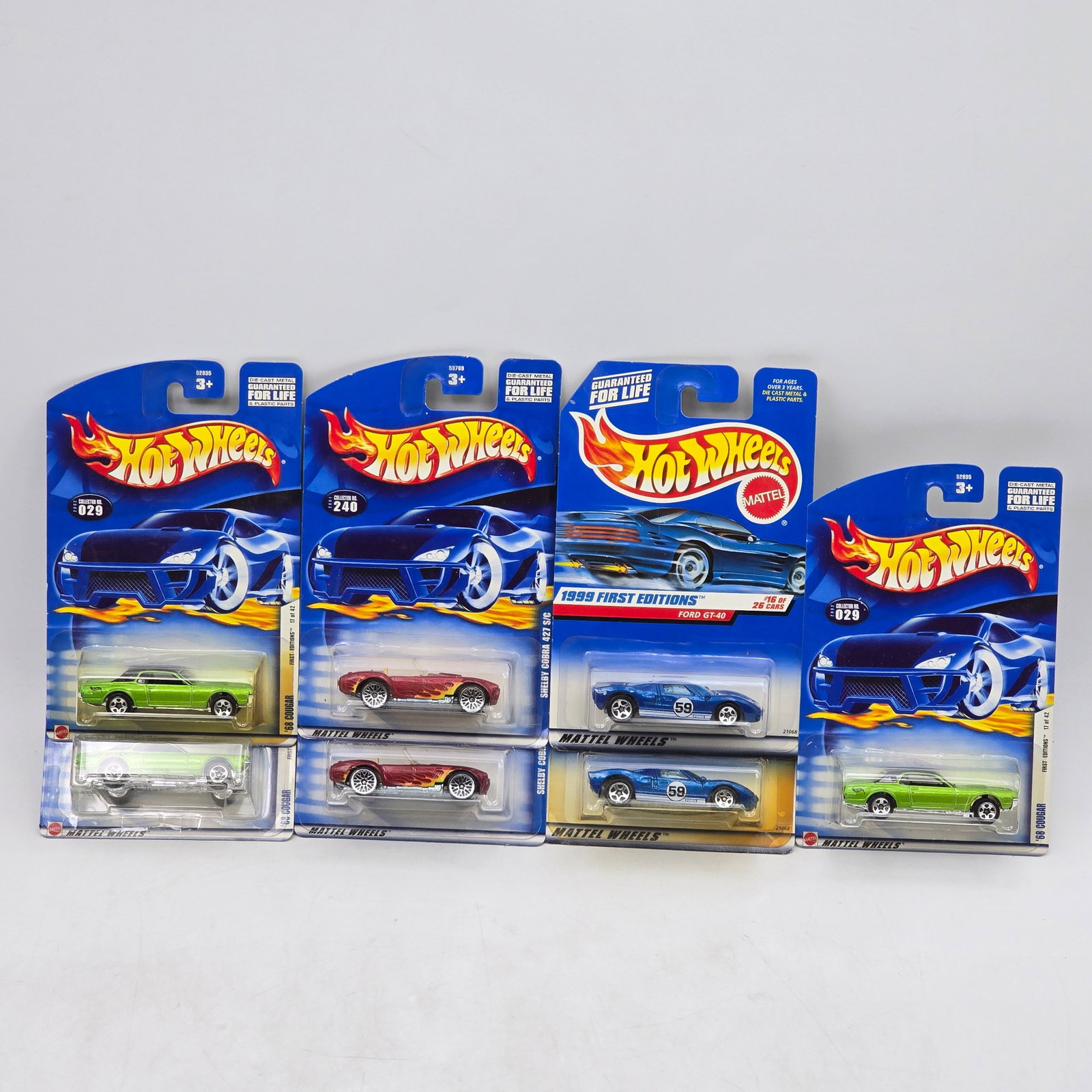 Lot Of 7 Hot Wheels Sports & Muscle Models: Lot of 7 Hot Wheels diecast vehicles featuring a mix of sports and muscle-style castings. Includes Ford GT40 First Editions models along with additional coupes and roadsters in blue, green, red, and s