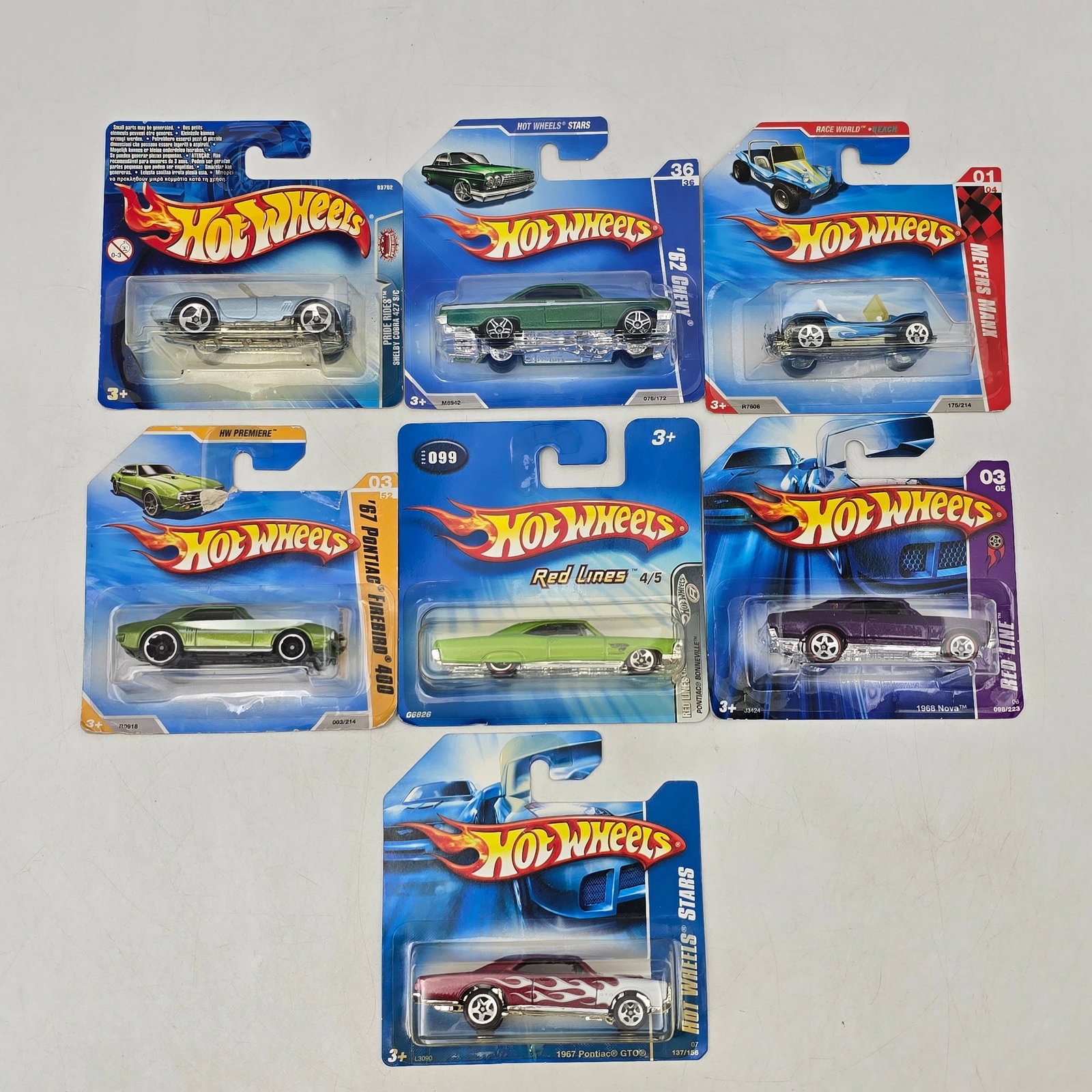 Lot Of 7 Hot Wheels Short Cards: Lot of 7 Hot Wheels diecast vehicles on short cards. Includes a mix of castings such as Chevy II, Meyers Manx, Pontiac Firebird 400, Pontiac GTO, and additional muscle and custom-style models in green