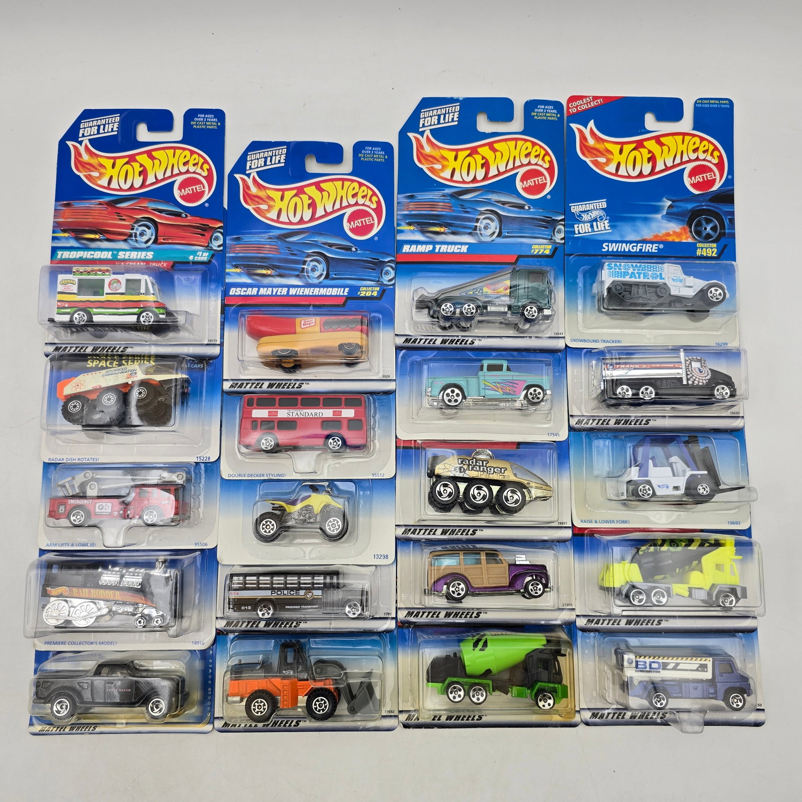 Lot Of 20 Hot Wheels Mixed Models: Lot of 20 Hot Wheels diecast vehicles featuring a wide mix of castings. Includes trucks, utility vehicles, buses, construction equipment, and custom builds in a variety of colors and graphic styles, w