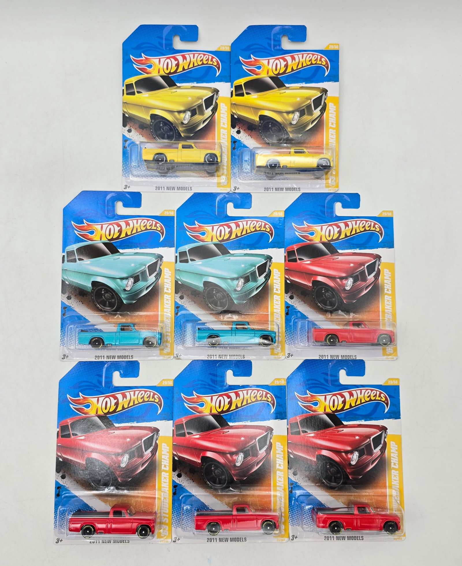 Lot of 8 Hot Wheels Studebaker Champ Variations: Group of 8 Hot Wheels diecast Studebaker Champ pickup castings from 2011 New Models releases, featuring multiple color variations including yellow, aqua, and red examples. A nicely matched truck-theme