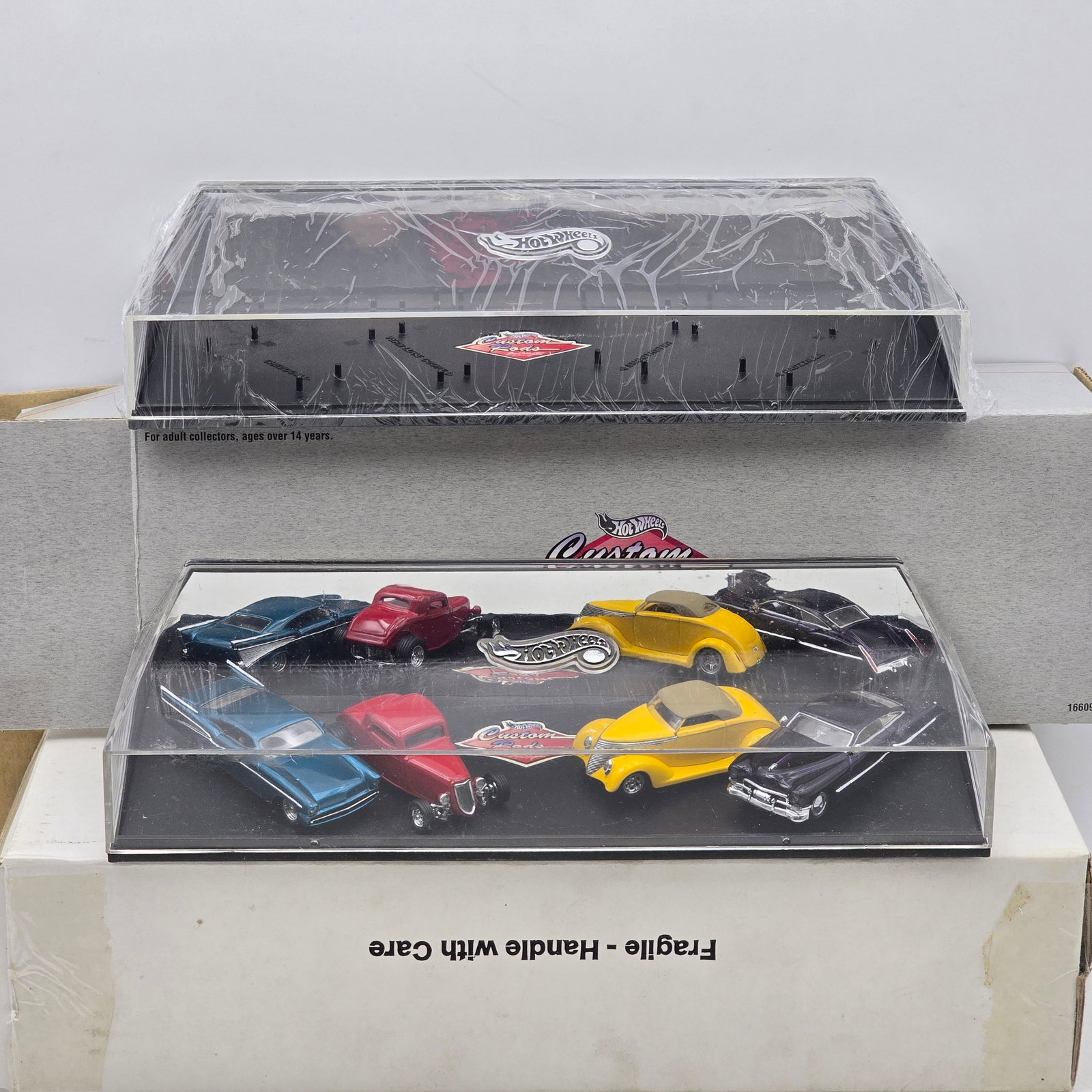 Hot Wheels Collectibles Custom Rods Boyd Coddington Set: Hot Wheels Collectibles Custom Rods display set featuring multiple custom vehicle designs inspired by legendary hot rod builder Boyd Coddington. This adult collector-oriented release showcases an asso