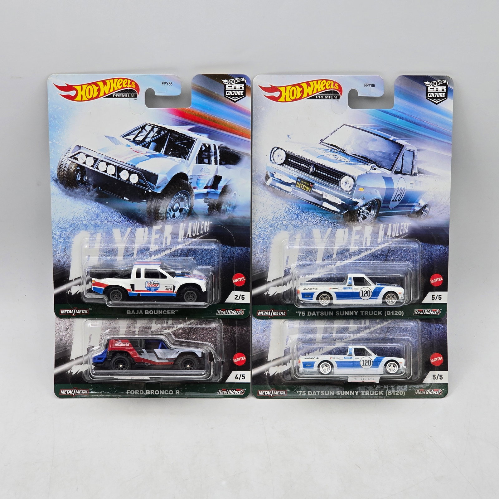 Lot of 4 Hot Wheels Premium Trucks: Includes Baja Bouncer, Ford Bronco R, and a pair of â€™75 Datsun Sunny Truck (B120) premium models from the Car Culture Cyber Speeder series. Cars-Look to be in good condition with no notable 