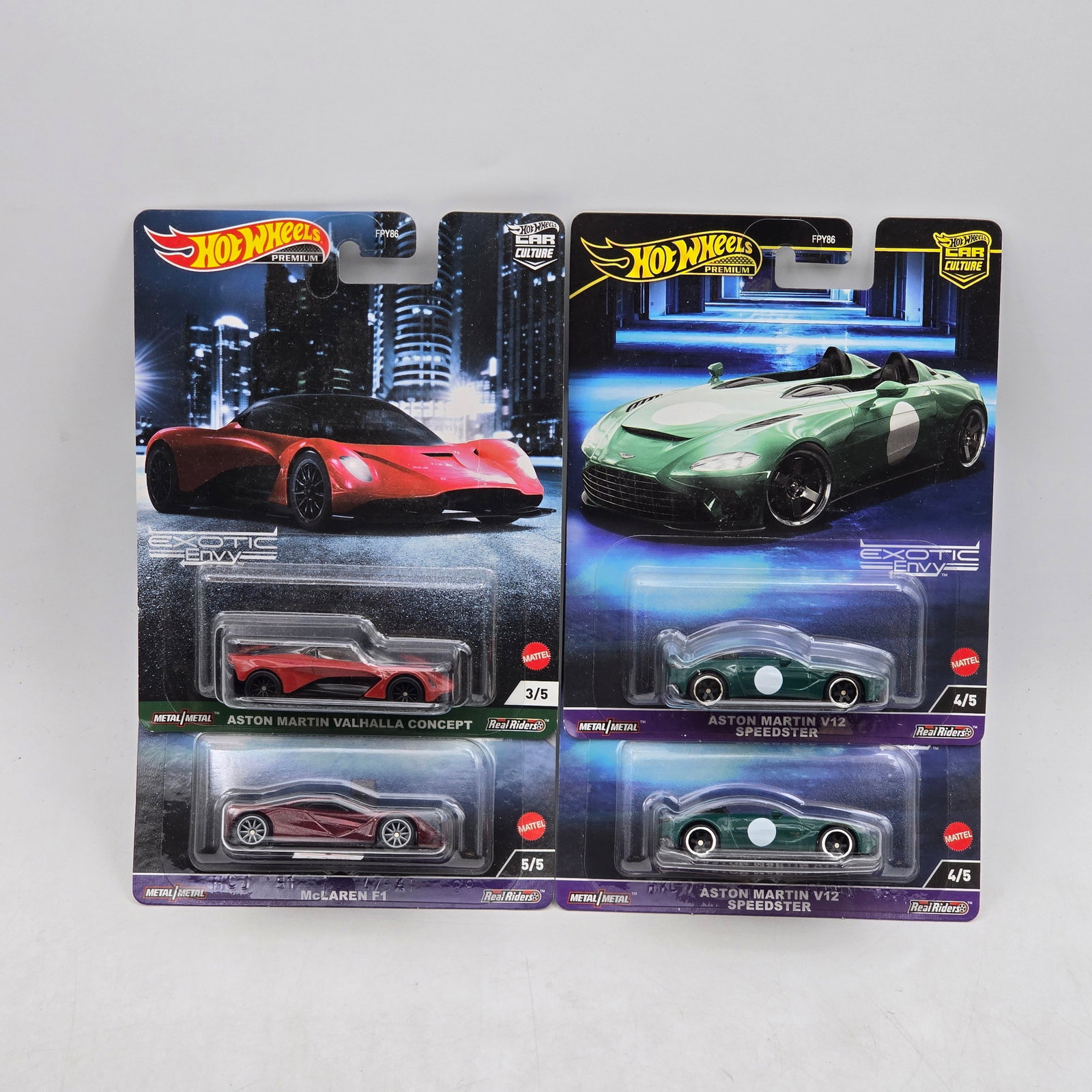 Lot of 4 Hot Wheels Exotic Envy Premiums: Includes Aston Martin Valhalla Concept, McLaren F1, and a pair of Aston Martin V12 Speedster premium models from the Car Culture Exotic Envy series. Cars-Look to be in good condition with no notable w