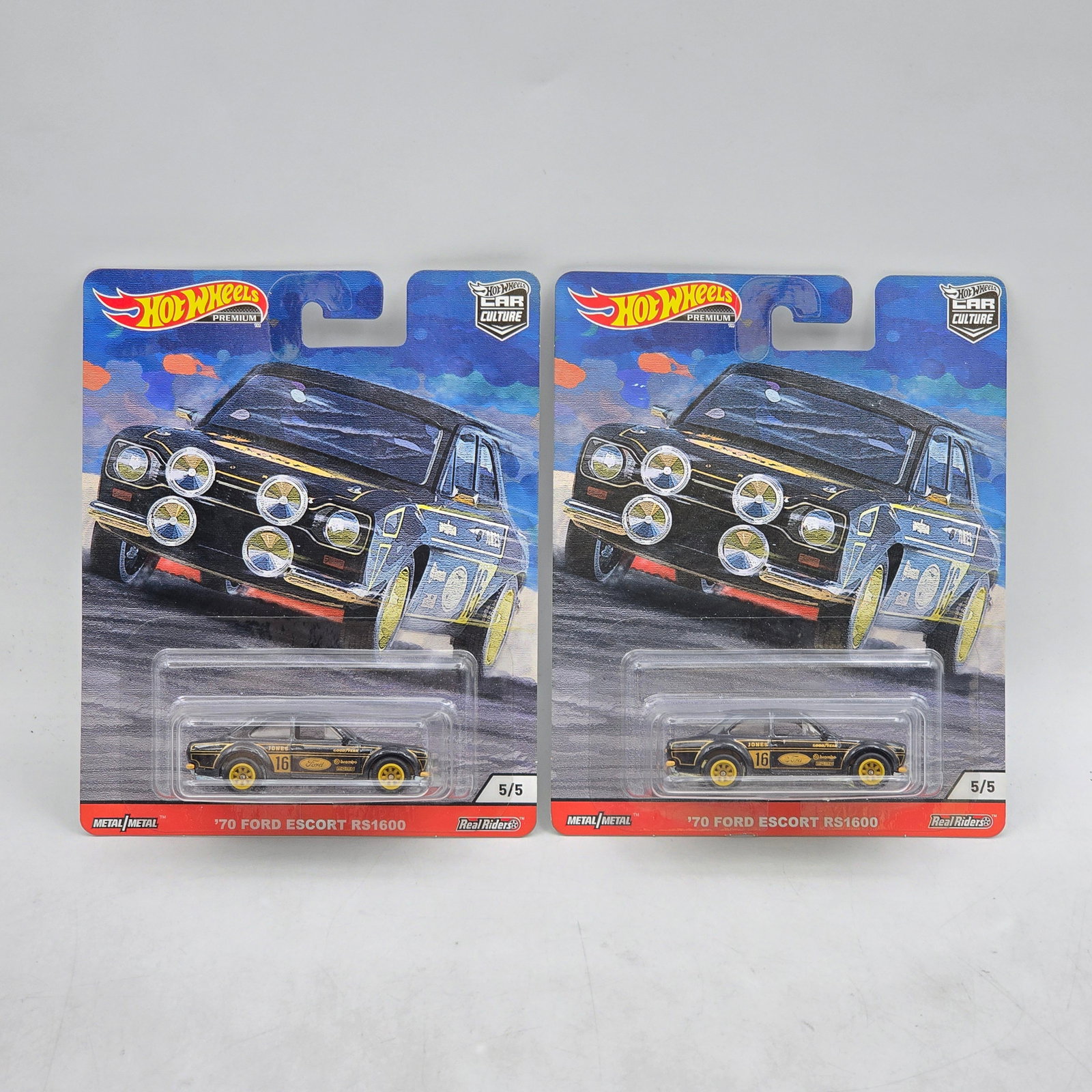 Pair of Hot Wheels Premiums: Includes (2) â€™70 Ford Escort RS1600 premium models from the Car Culture series. Cars-Look to be in good condition with no notable wear visible. Paint, tampos, glass, base and Real Riders whe