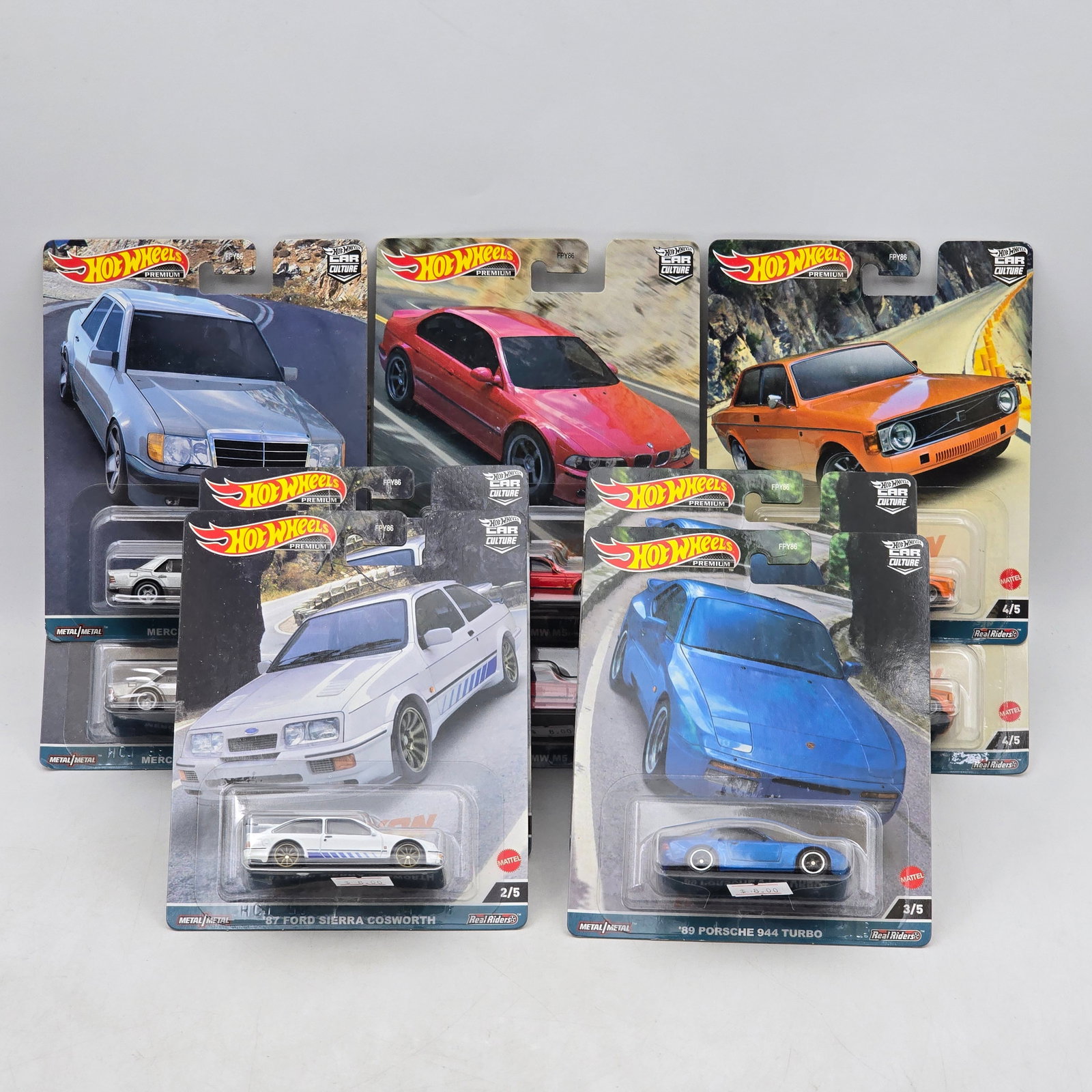 Lot of 10 Hot Wheels Canyon Warriors Premiums: Includes two complete Canyon Warriors 5-car premium sets featuring BMW M5, Ford Sierra Cosworth, Porsche 944 Turbo, â€™73 Volvo 142 GL, and Mercedes-Benz 500 E models. Cars-Appear to be in goo