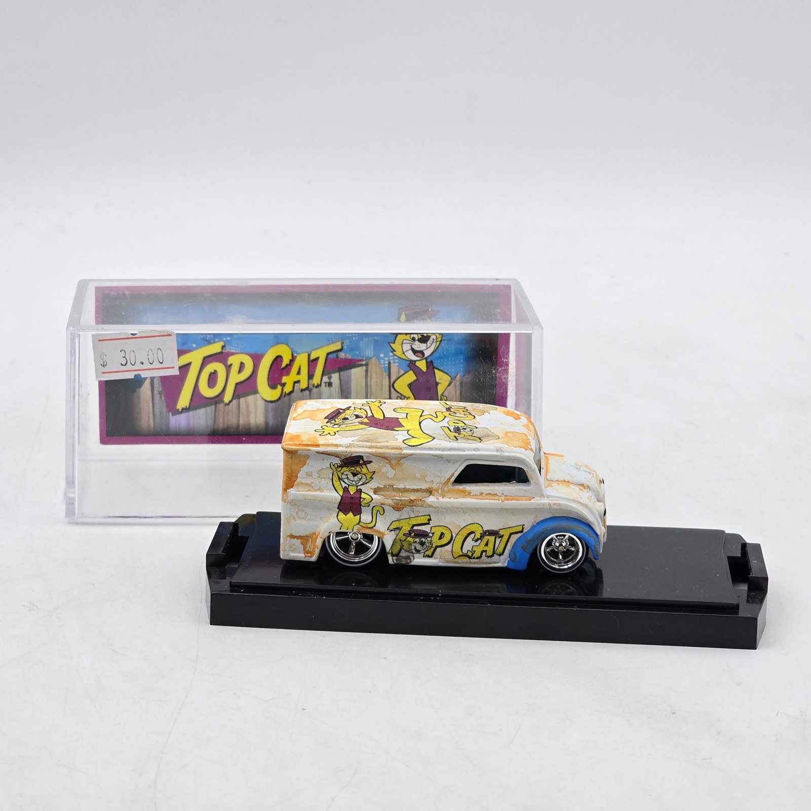 Chris Stangler Customs Top Cat Dairy Delivery: Hand-built custom panel van by Chris Stangler Customs featuring distressed white-and-orange paint, Top Cat cartoon graphics, and custom chrome wheel detail. Includes matching themed backdrop insert