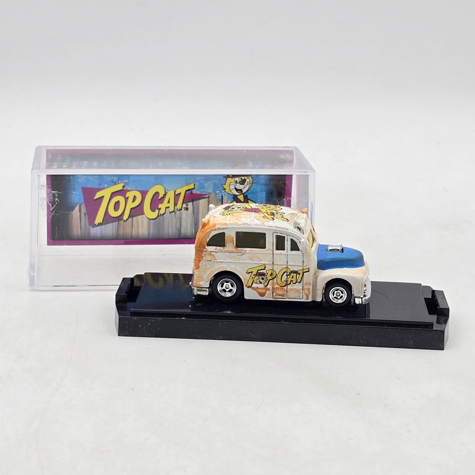 Chris Stangler Customs Top Cat School Busted Van: Hand-built custom van by Chris Stangler Customs featuring distressed white-and-orange paint, blue front-end accents, and Top Cat cartoon graphics throughout the body and roof. Vehicle-Looks to be in