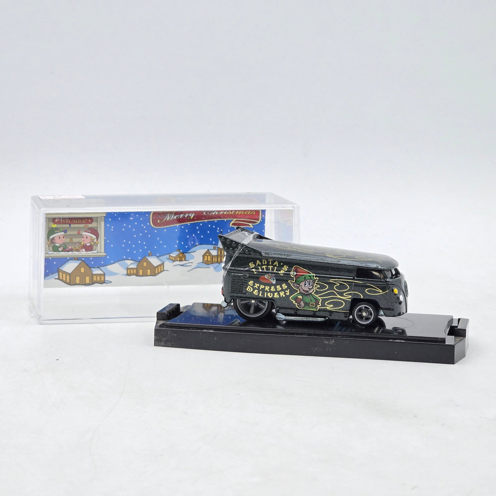 Chris Stangler Customs Santaâ€™s Little Express Delivery Drag Bus: Hand-built custom Volkswagen-style Drag Bus by Chris Stangler Customs featuring black paint with gold pinstriping, holiday-themed graphics, and raised drag-style stance. Includes matching winter holid