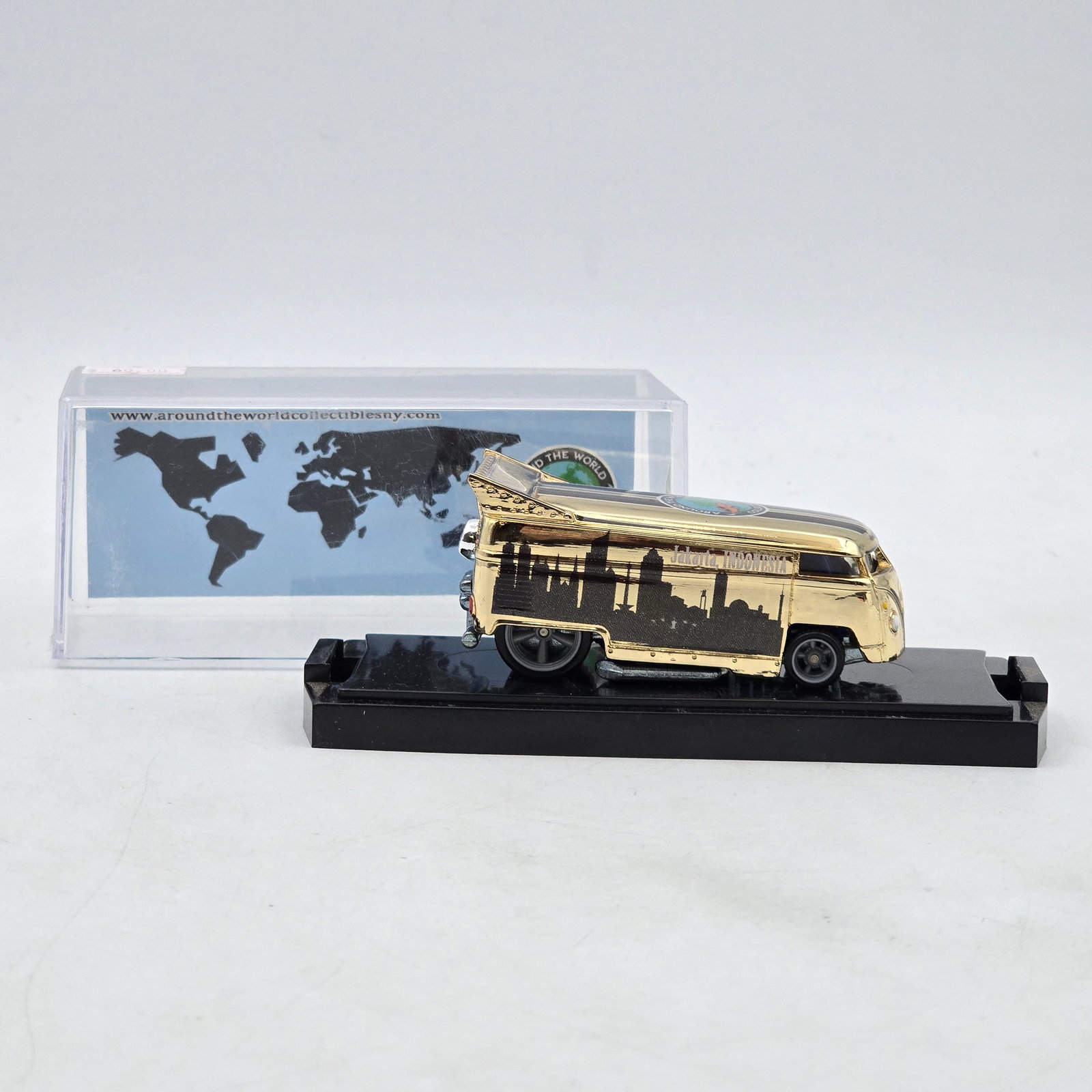 Chris Stangler Customs Around the World Drag Bus: Hand-built custom Volkswagen-style Drag Bus by Chris Stangler Customs featuring gold chrome-style finish, black city skyline graphics, and raised drag-style stance. Includes Around the World