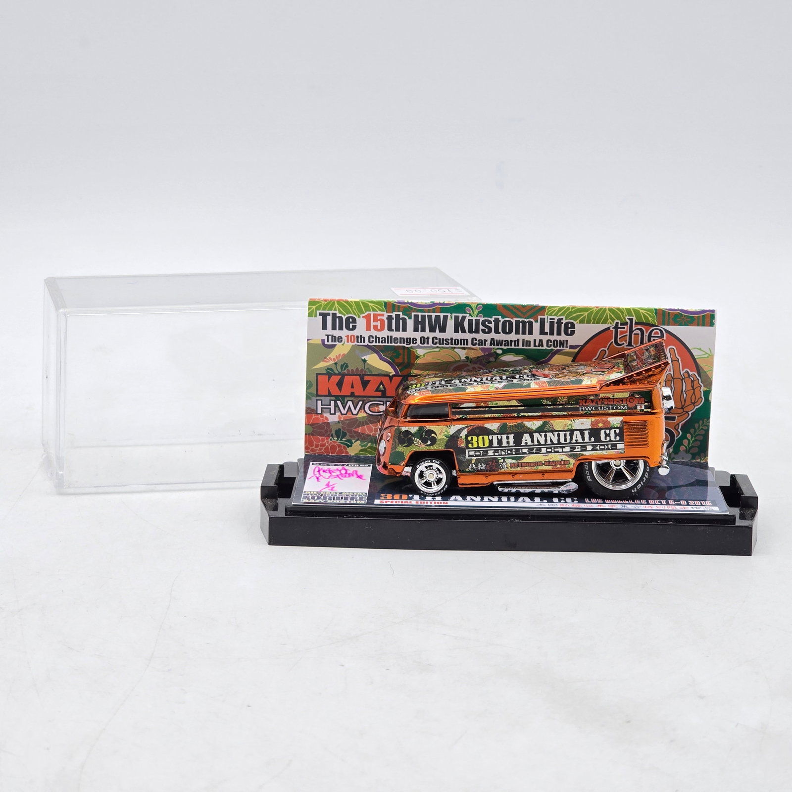 Kazy Kustom 30th Annual C.C. VW Drag Bus: Custom Volkswagen-style Drag Bus by Kazy Kustom featuring reflective orange chrome-style finish, multicolor Japanese-inspired graphics, and raised drag-style rear wing. Produced for the 30th Annual C.