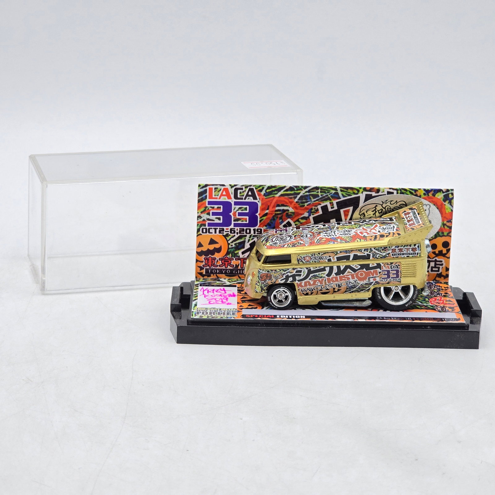 Kazy Kustom LA CA 33 VW Drag Bus: Custom Volkswagen-style Drag Bus by Kazy Kustom featuring gold chrome-style finish, dense multicolor Japanese-inspired graphics, and raised drag-style rear wing. Produced for the LA CA 33 event held O