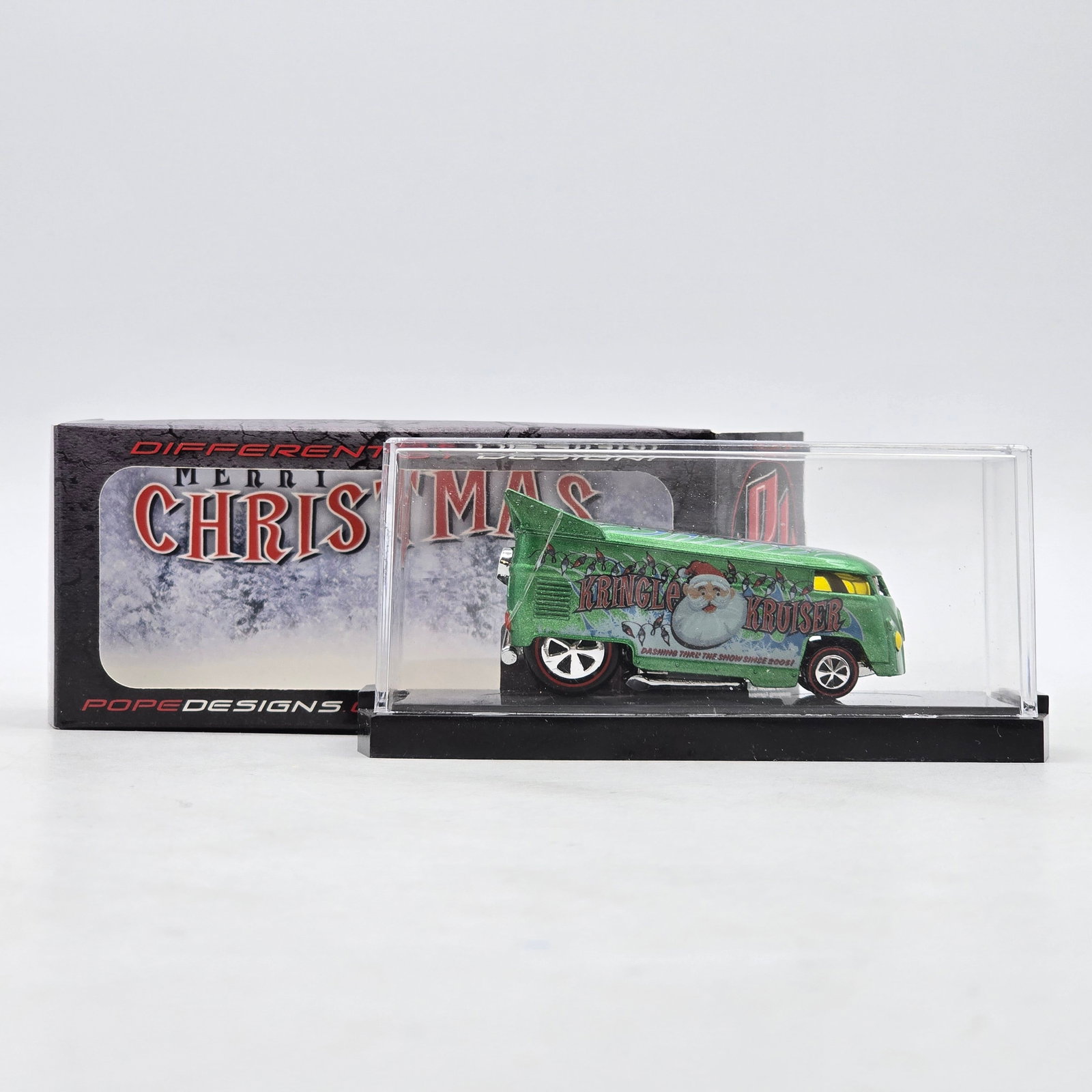Pope Designs Kringle Kruiser VW Drag Bus: Custom Volkswagen-style Drag Bus by Pope Designs featuring metallic green finish, festive â€?Kringle Kruiserâ€? Christmas graphics, Santa Claus artwork, and raised drag-style rear wing. In