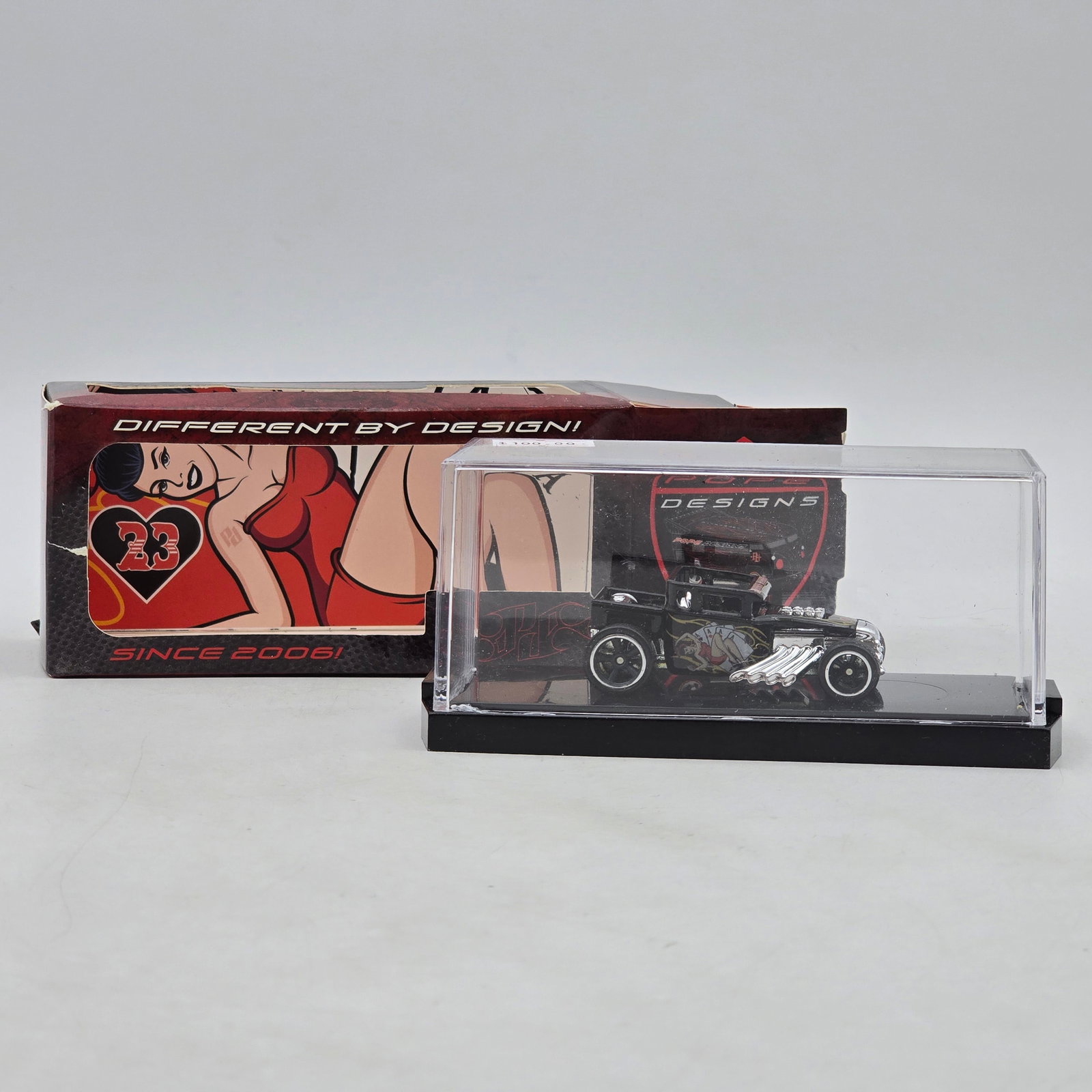 Pope Designs Pin-Up Boneshaker Custom: Custom hot rod-style diecast by Pope Designs based on the popular Boneshaker casting, featuring pin-up artwork, exposed chrome engine and side pipes, and blacked-out custom styling. Individually numbe