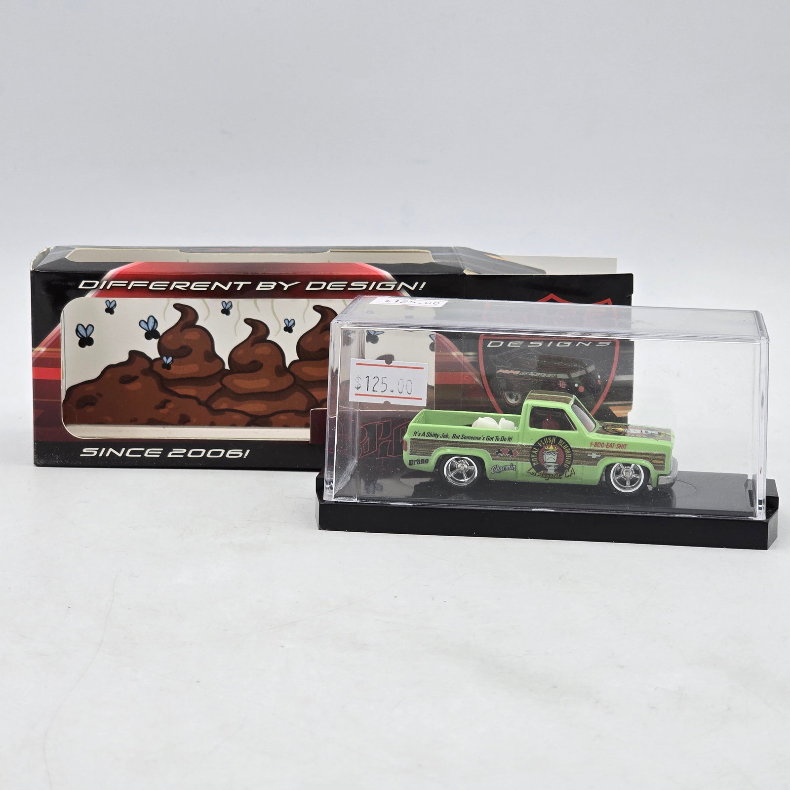 Pope Designs Royal Flush Plumbing Custom Pickup: Custom pickup truck by Pope Designs featuring humorous â€?Royal Flush Plumbingâ€? graphics with cartoon-style artwork and bright service truck-inspired livery. Individually numbered 04/20 